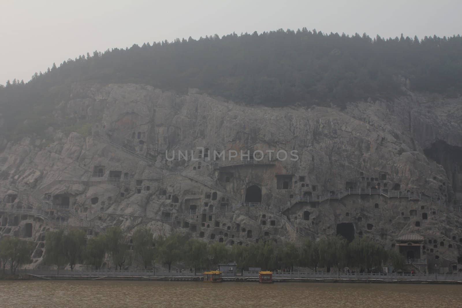 Longmen grottes, a UNESCO World Heritage Site, and Yi River, on a foggy day
