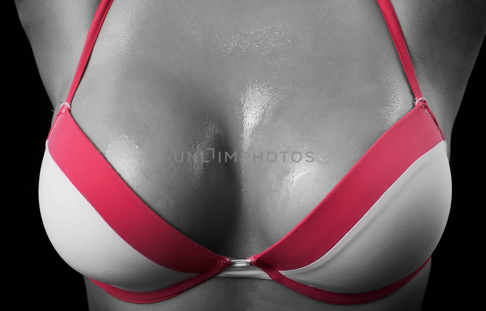 Woman breast in uplift on a black background