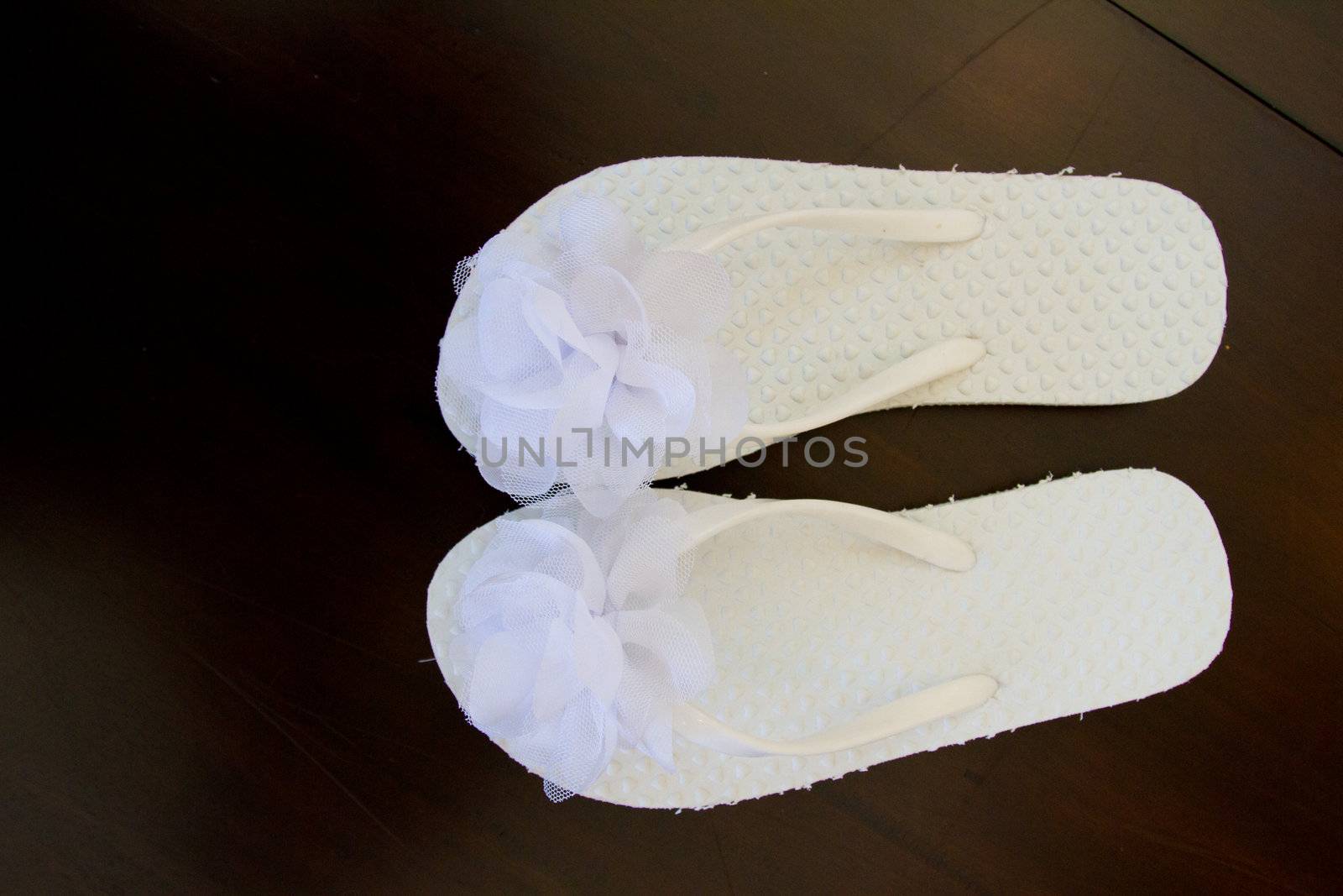 Simple white flip flop sandals for a bride to wear on her wedding day.