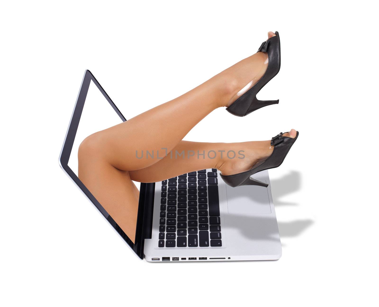 sexy legs coming out from the screen of the laptop isolated on white background