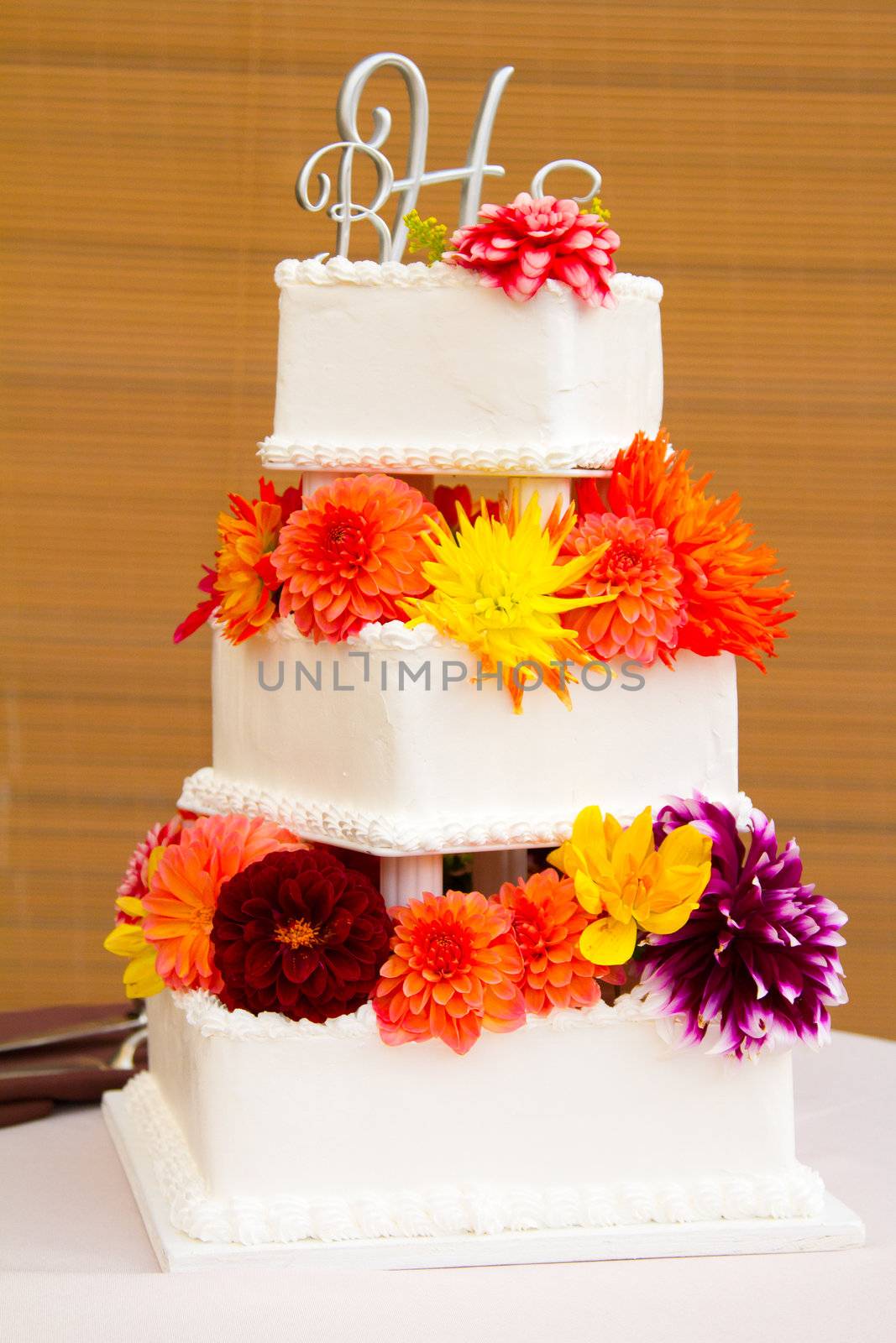 A very traditional white wedding cake at the reception for a bride and groom on their wedding day.