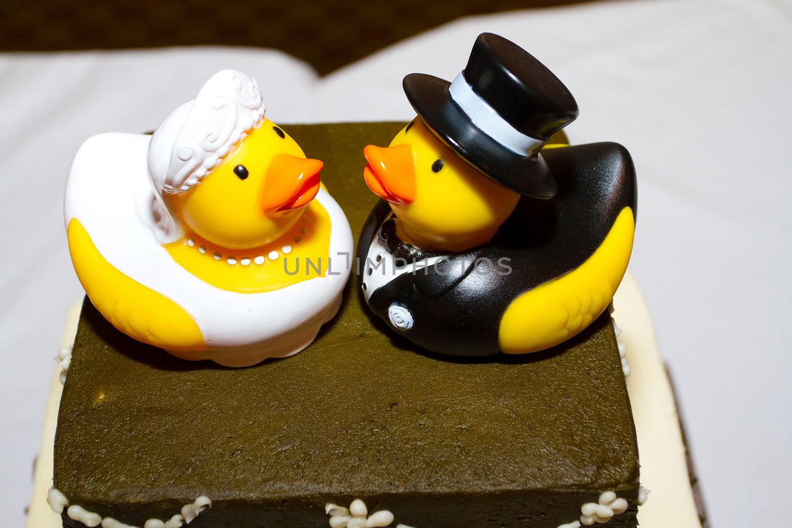 Rubber ducks are the cake toppers for this wedding cake at a very non-traditional reception for the bride and groom.