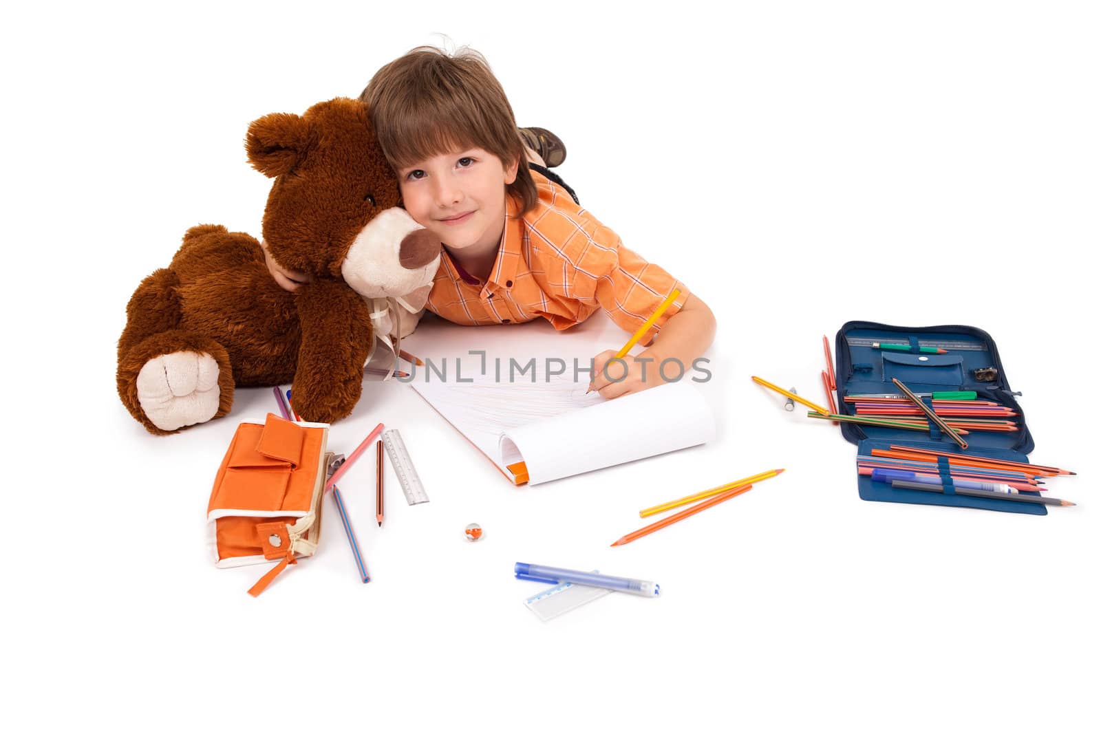 Happy little boy with notebook and teddy bear by ra2studio