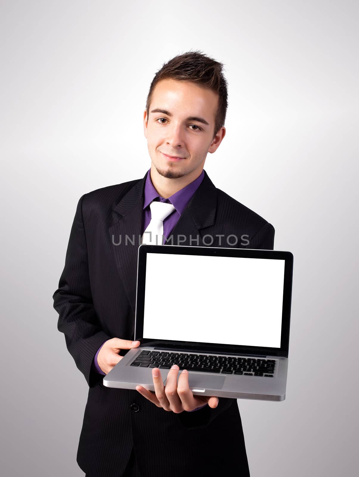Young man showing a work presentation on laptop by ra2studio