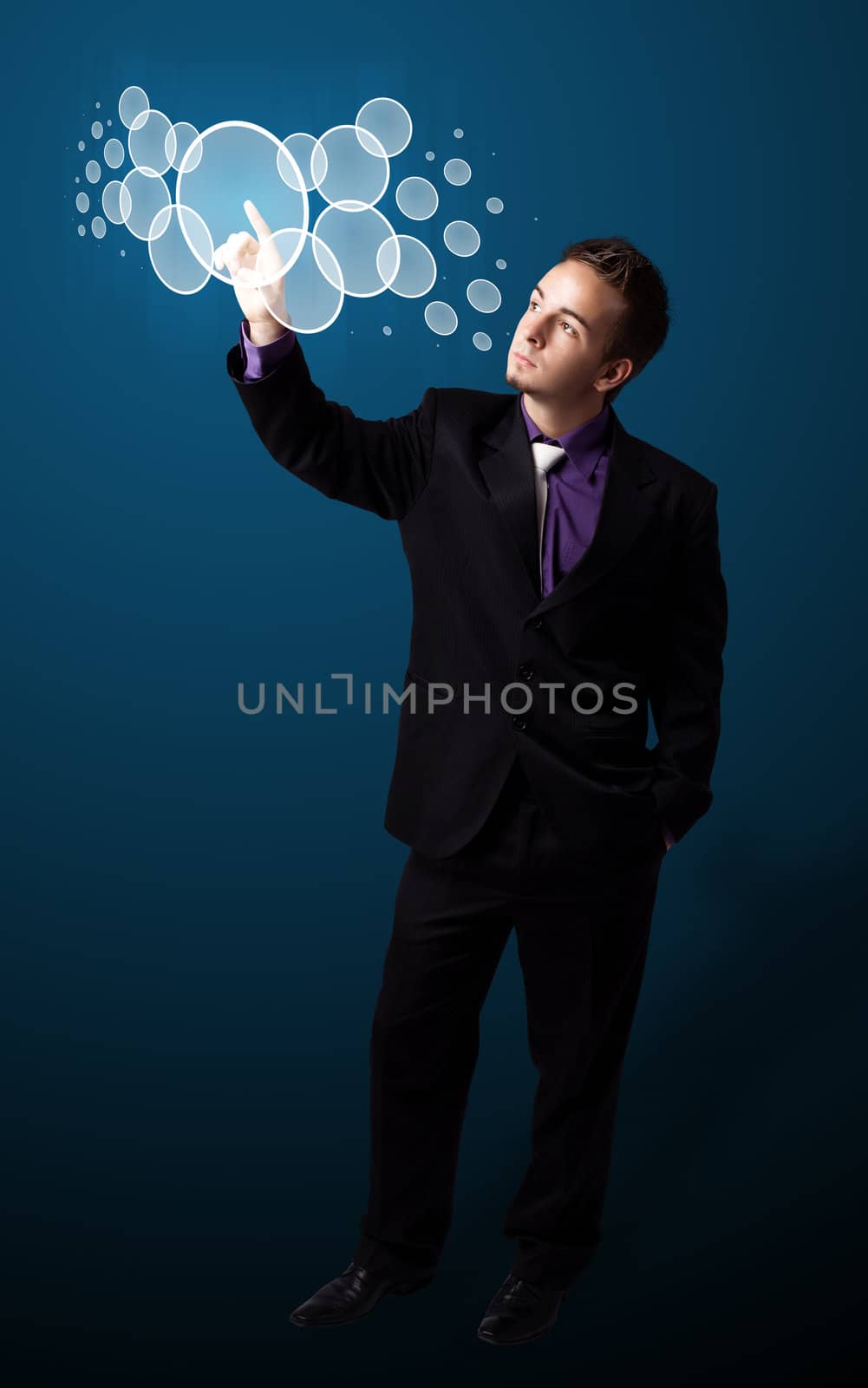 Businessman pressing high tech type of modern buttons on a virtual background