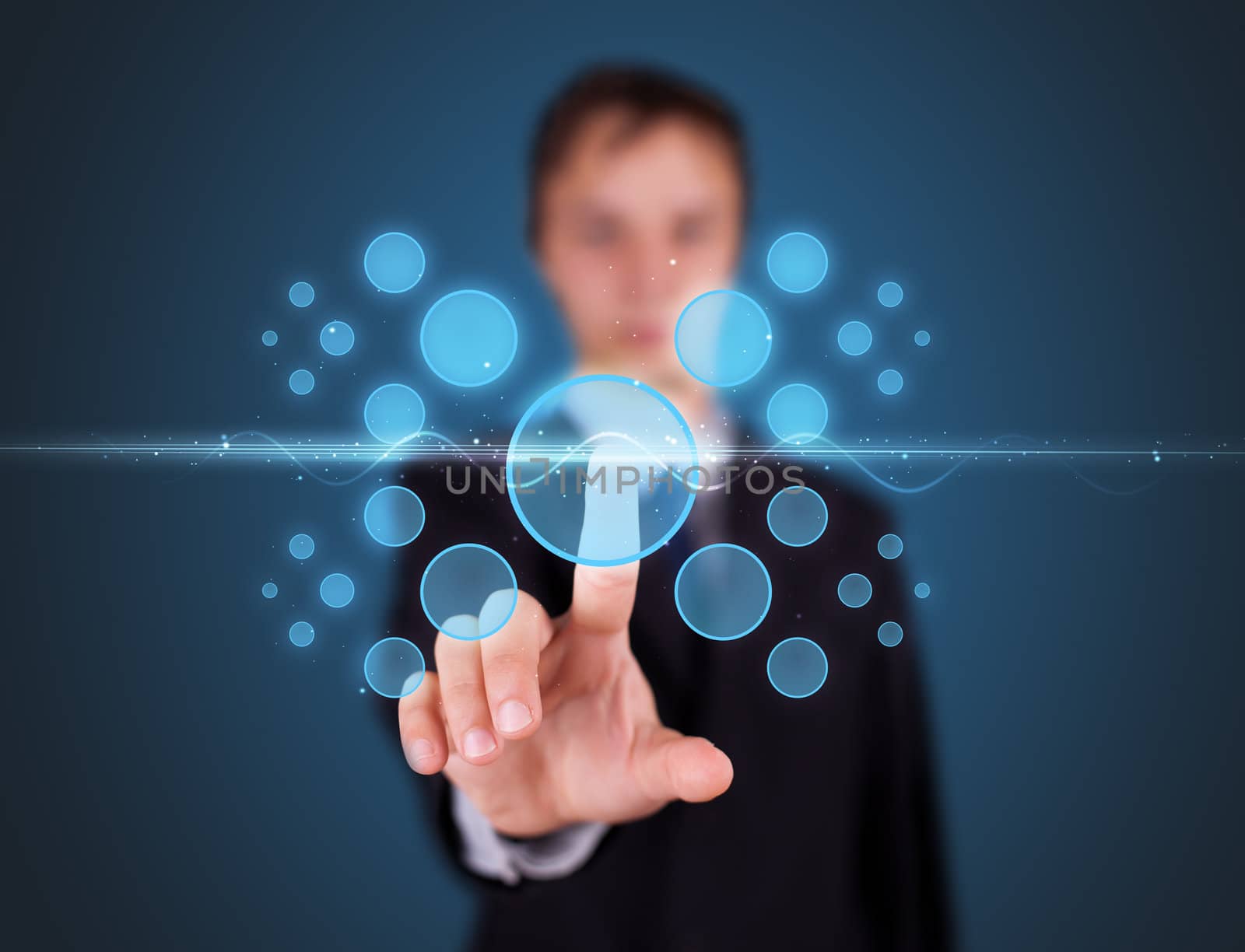 Businessman pressing high tech type of modern buttons on a virtual background