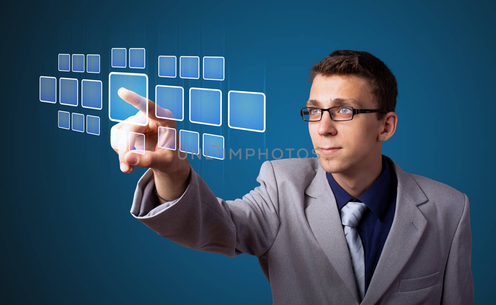 Businessman pressing high tech type of modern buttons on a virtual background