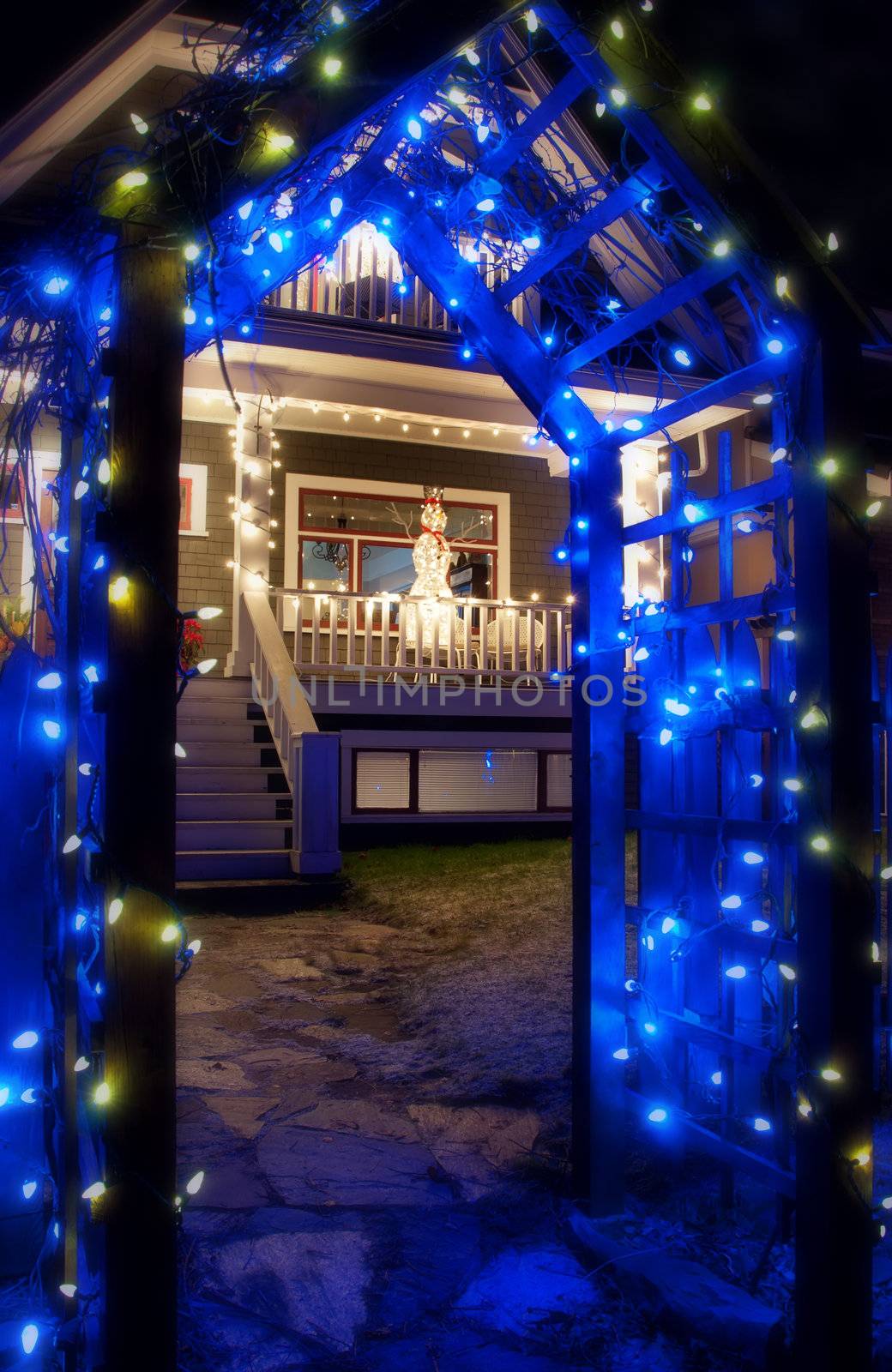 Blue Christmas Light Archway in front of house with snowman