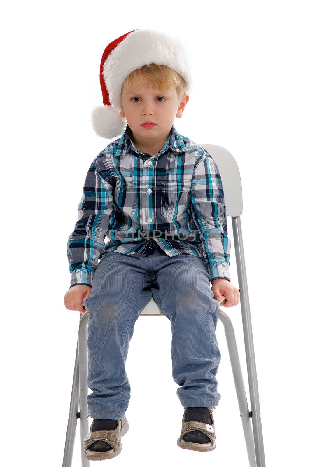 Little Boy with Santa Hat Sitting on Chair and Asking "I'm not Santa?" 