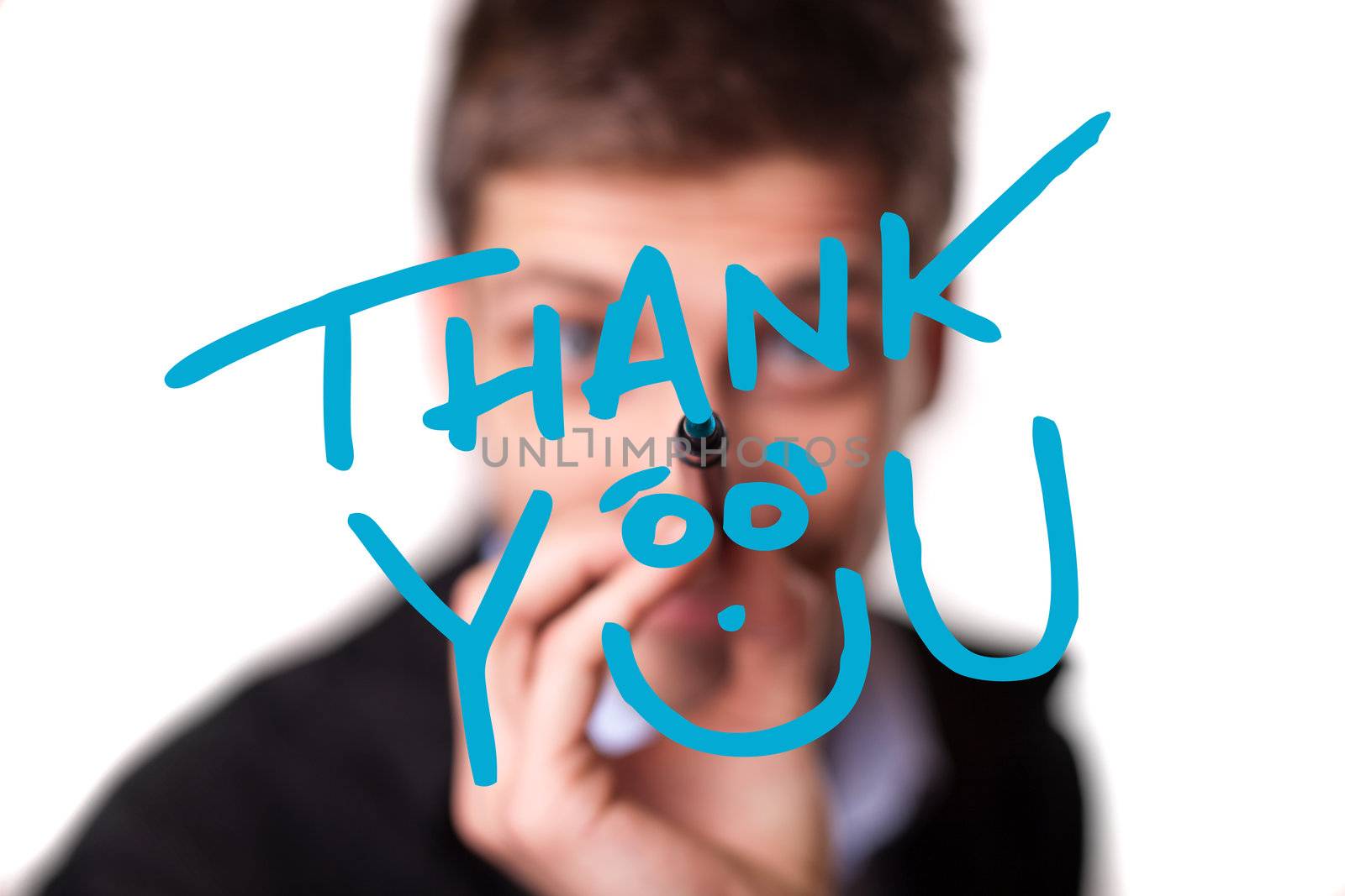 Young man writing Thank YOU on whiteboard, selective focus