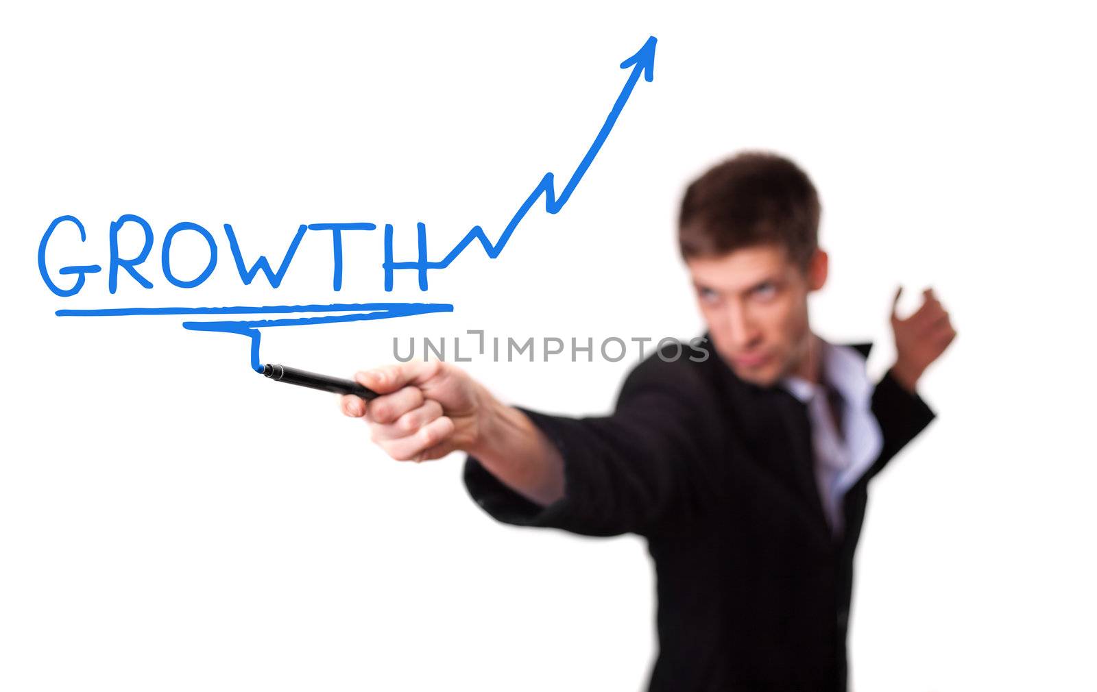 Businessman drawing a rising arrow, representing business growth (selective focus)