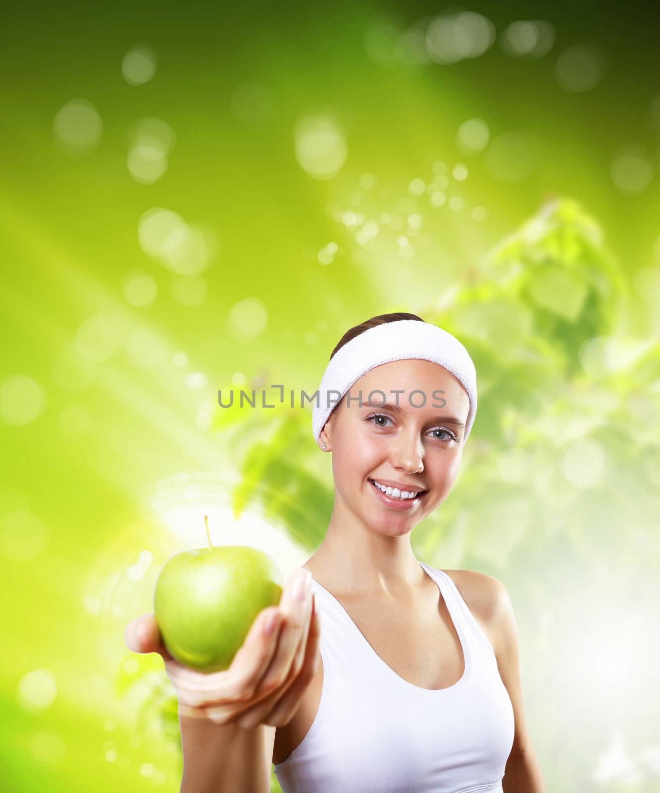 Young pretty girl in sport wear with green apple