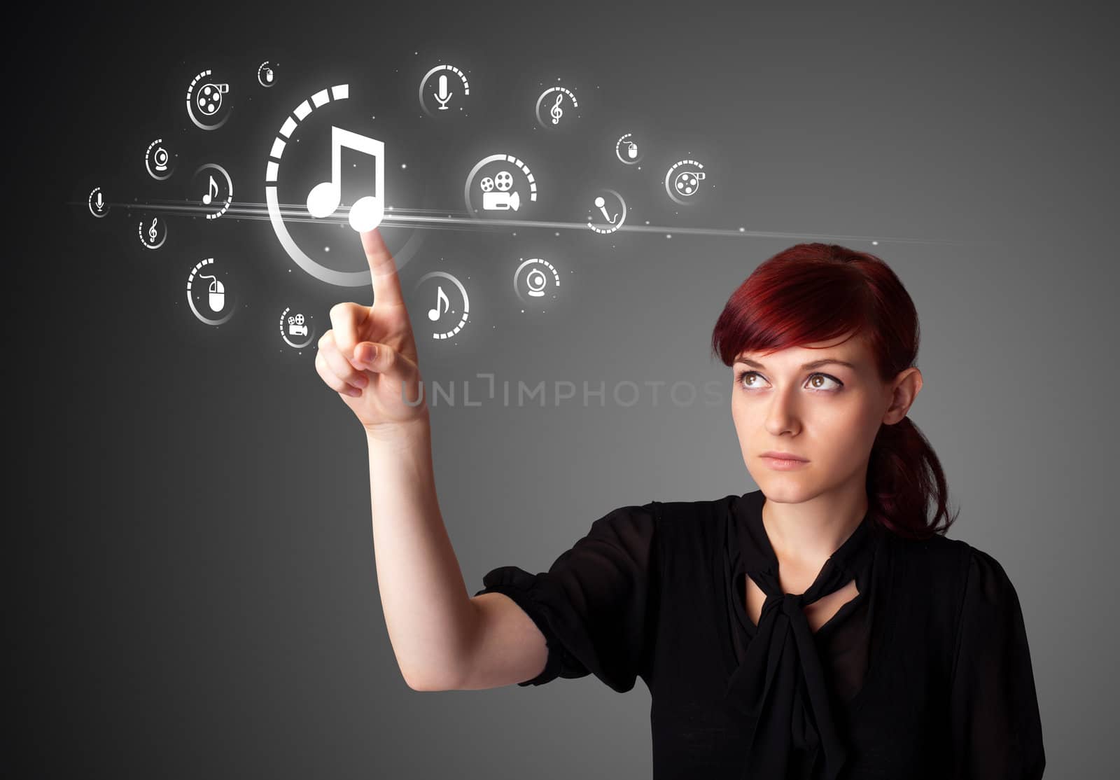 Businesswoman pressing virtual media type of buttons by ra2studio