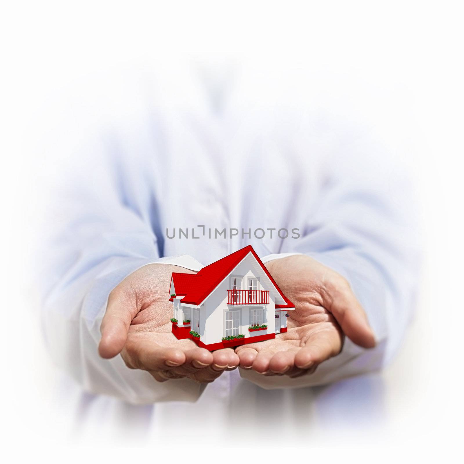 Residential building and a businessman holding it in his hands