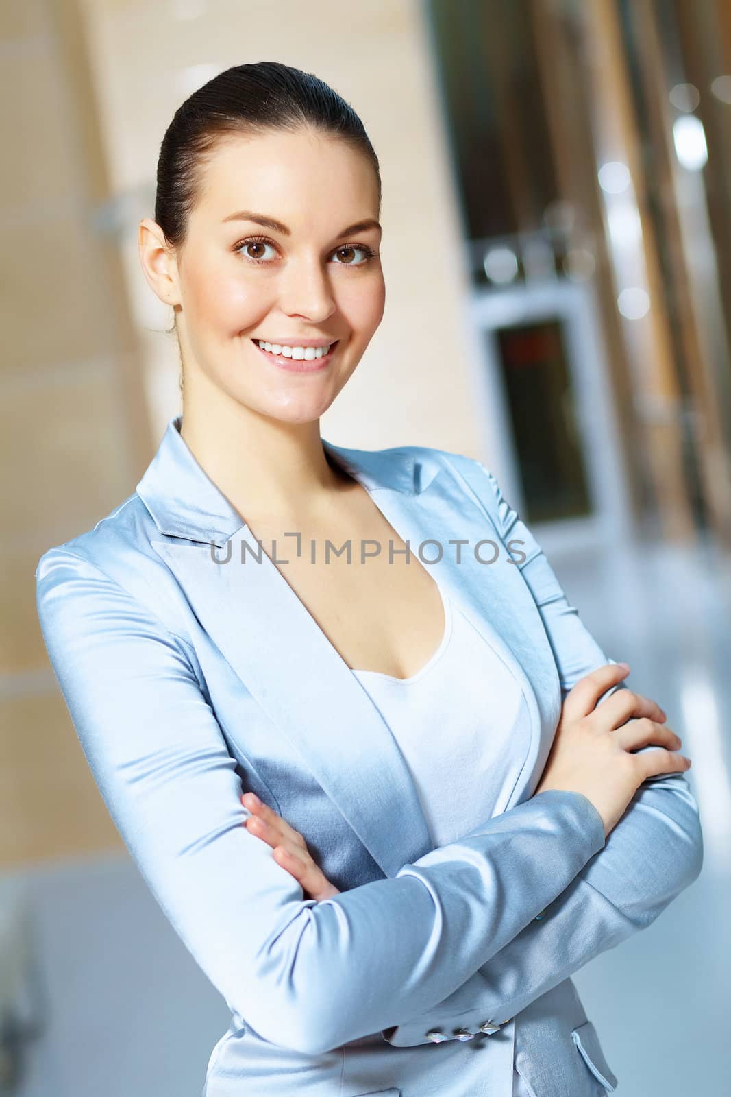 Portrait of happy smiling young businesswoman in office