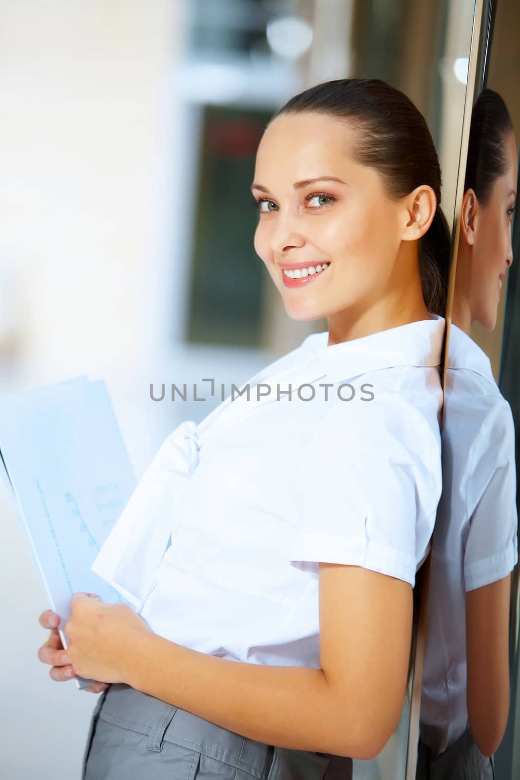 Portrait of happy smiling young businesswoman in office