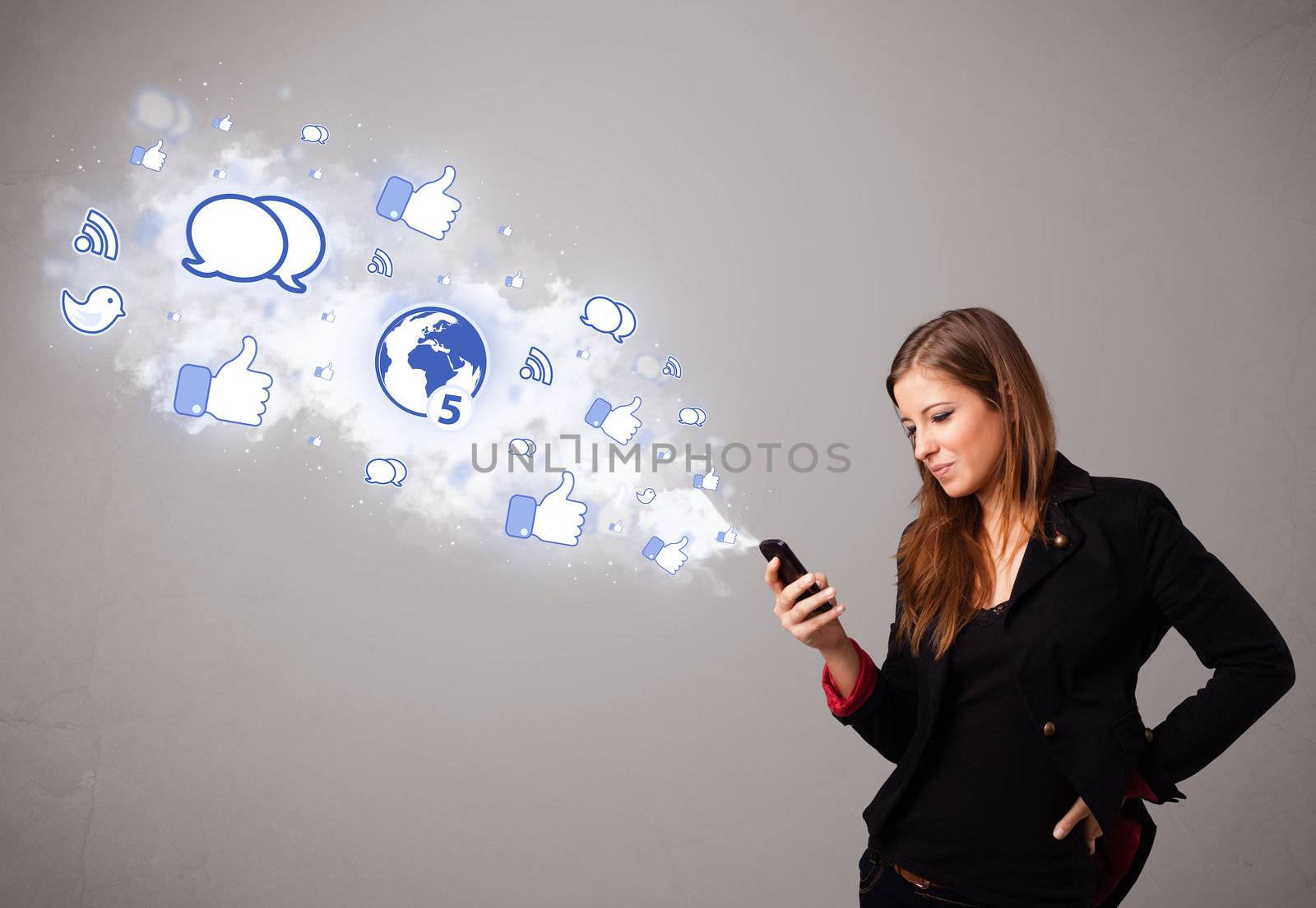Pretty young girl holding a phone with social media icons in abstract cloud