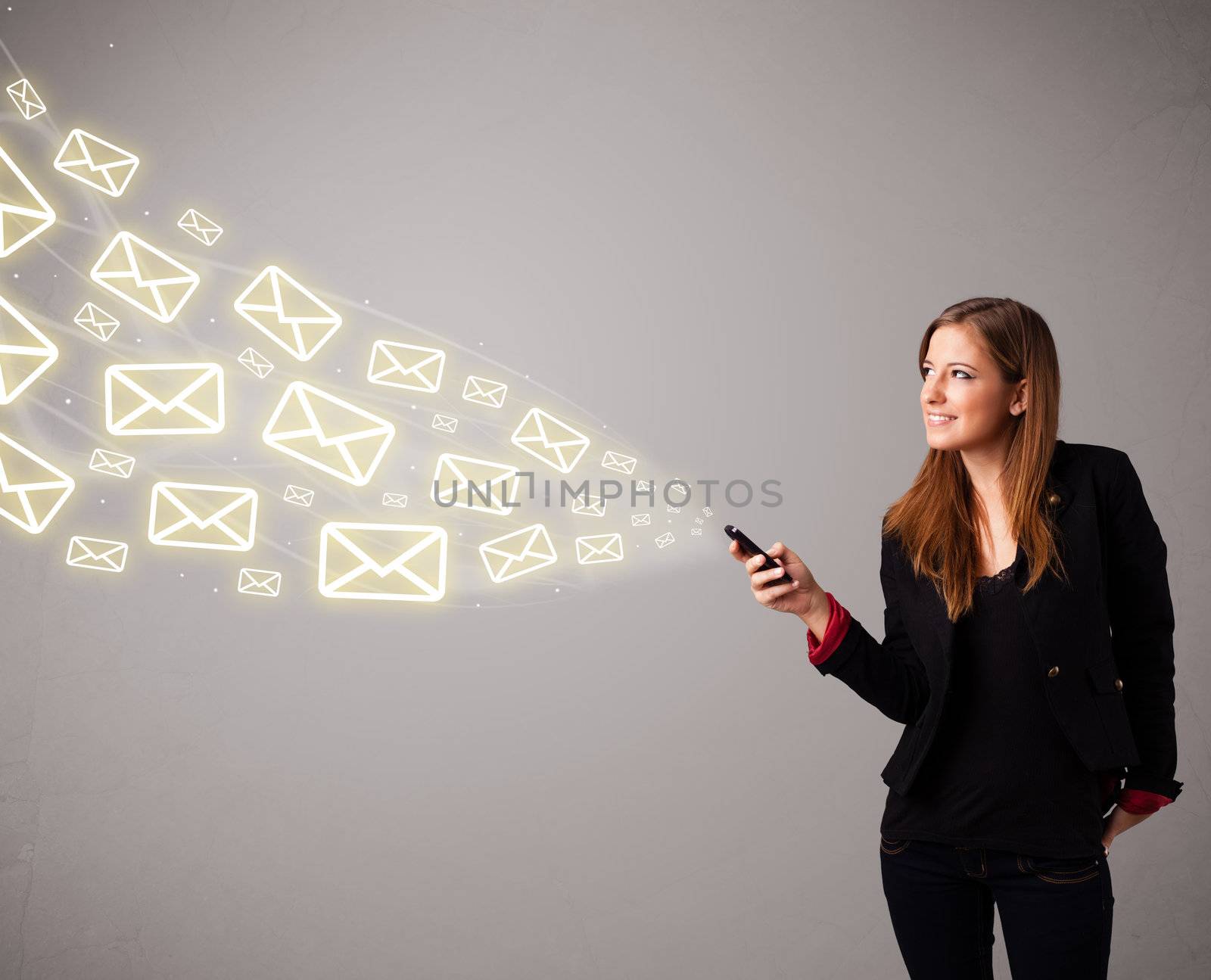 attractive young lady standing and holding a phone with message icons