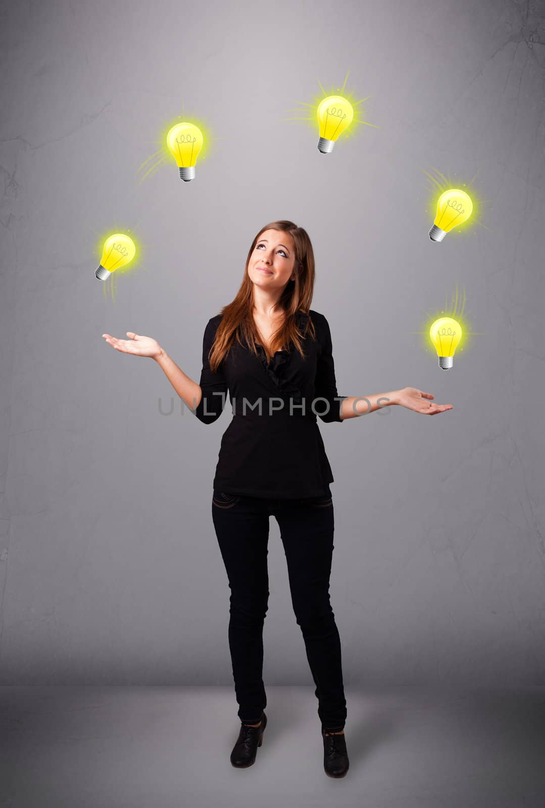 beautiful young lady standing and juggling with light bulbs