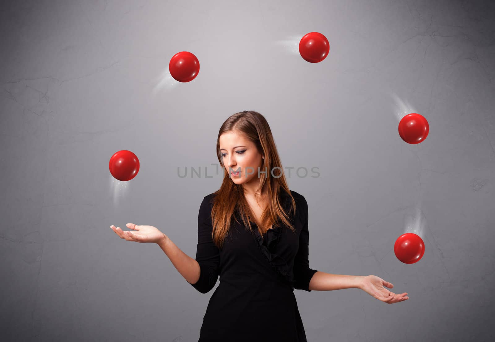 pretty young girl standing and juggling with red balls