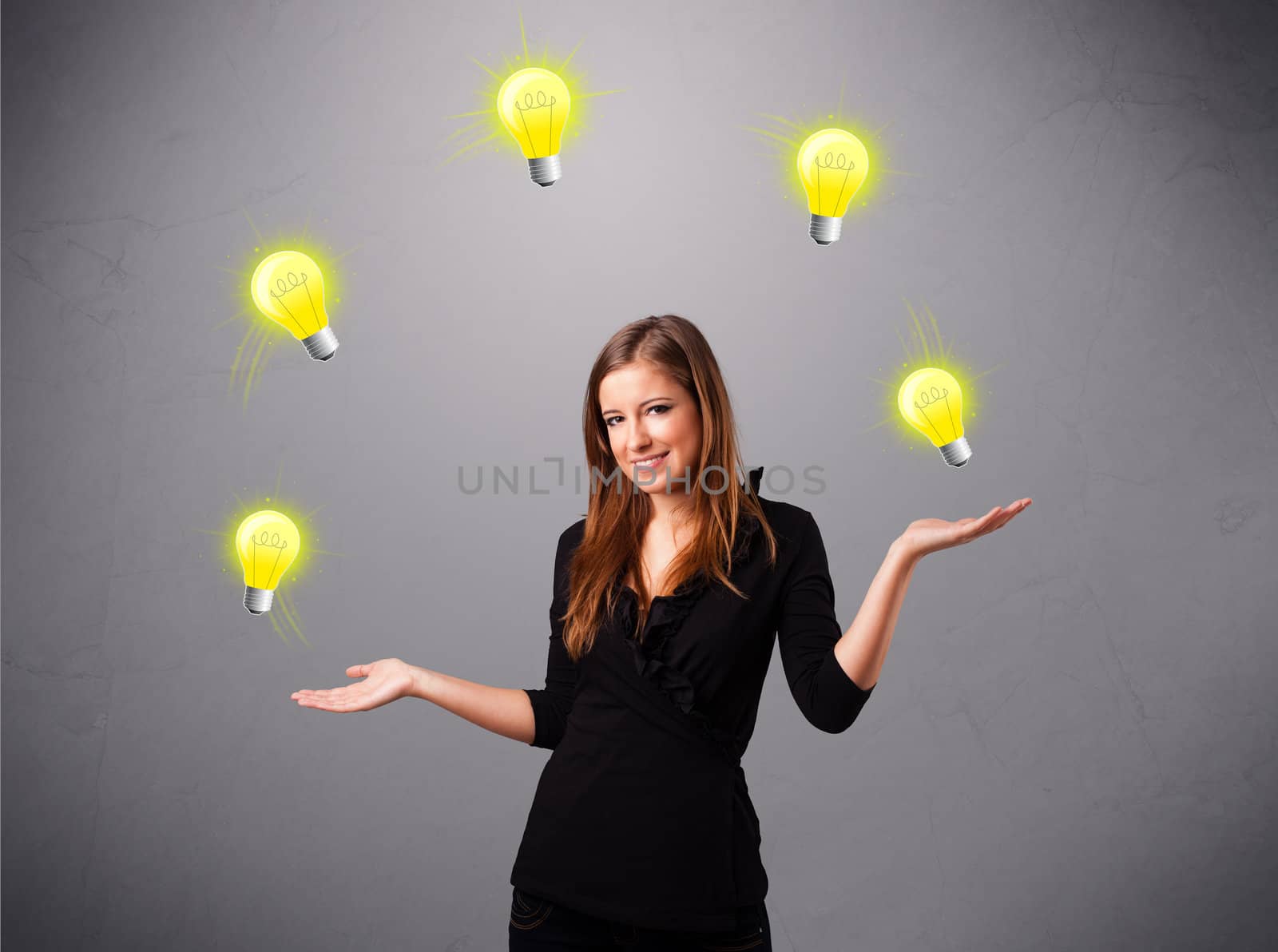 beautiful young lady standing and juggling with light bulbs