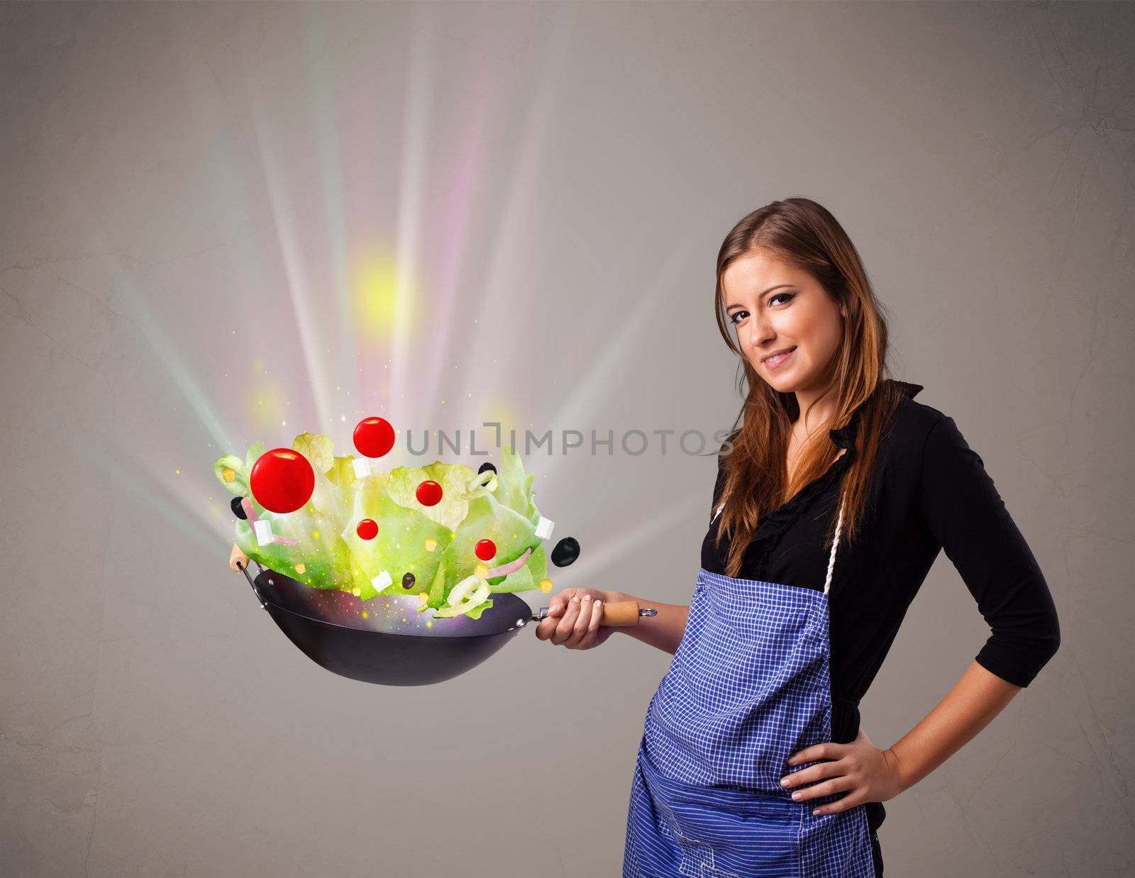 Young woman cooking fresh vegetables by ra2studio