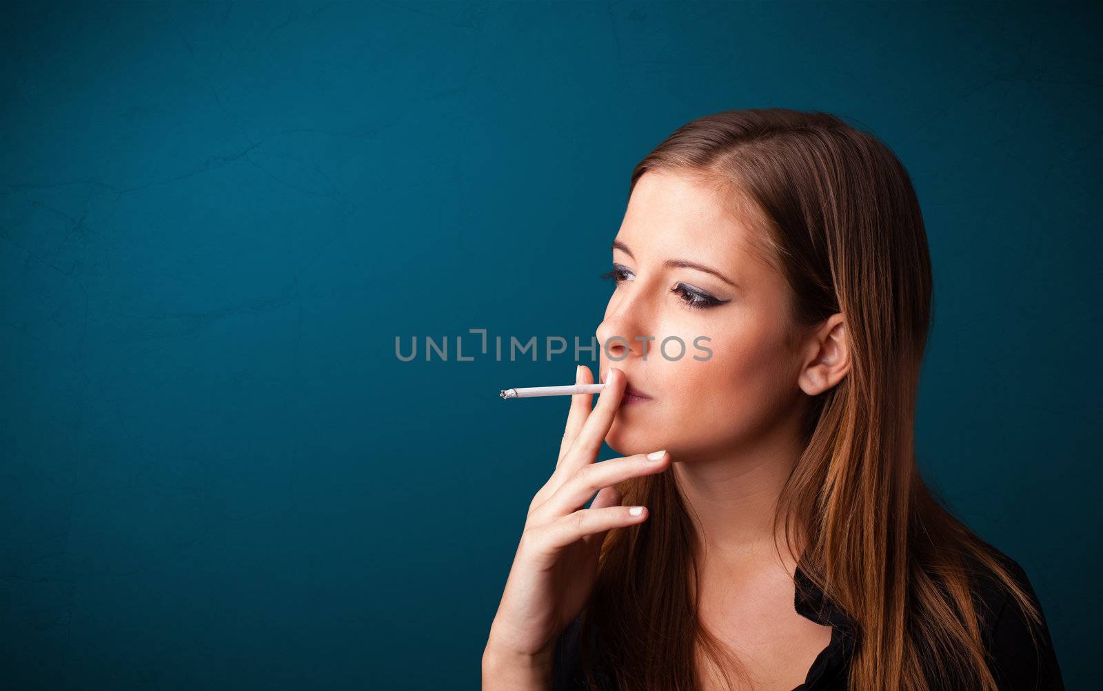 Beautiful woman smoking cigarette vith copy space by ra2studio