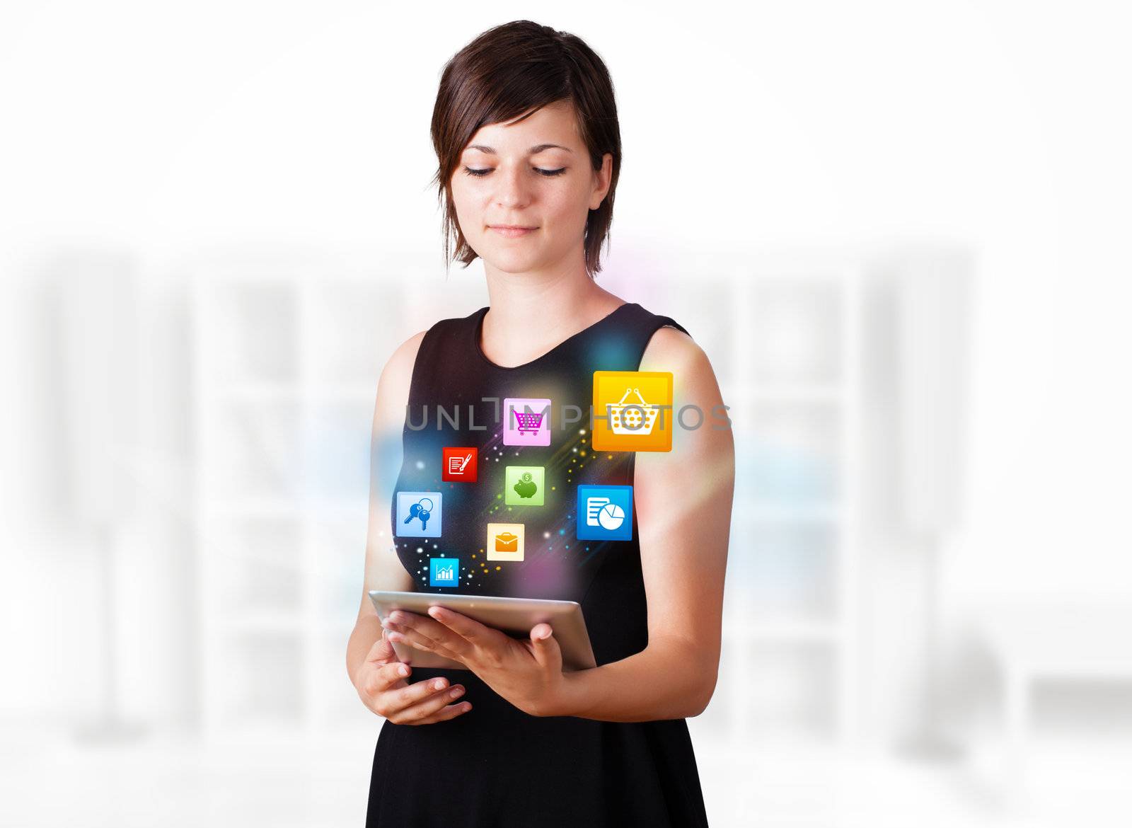 Young woman looking at modern tablet with colourful icons by ra2studio