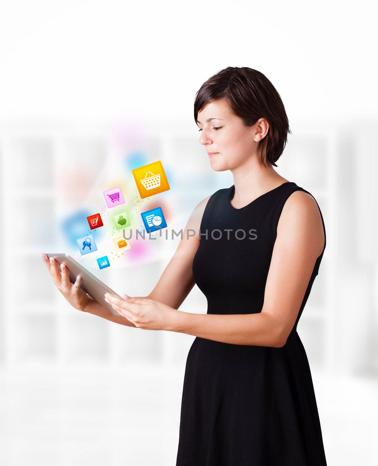 Young woman looking at modern tablet with colourful icons by ra2studio