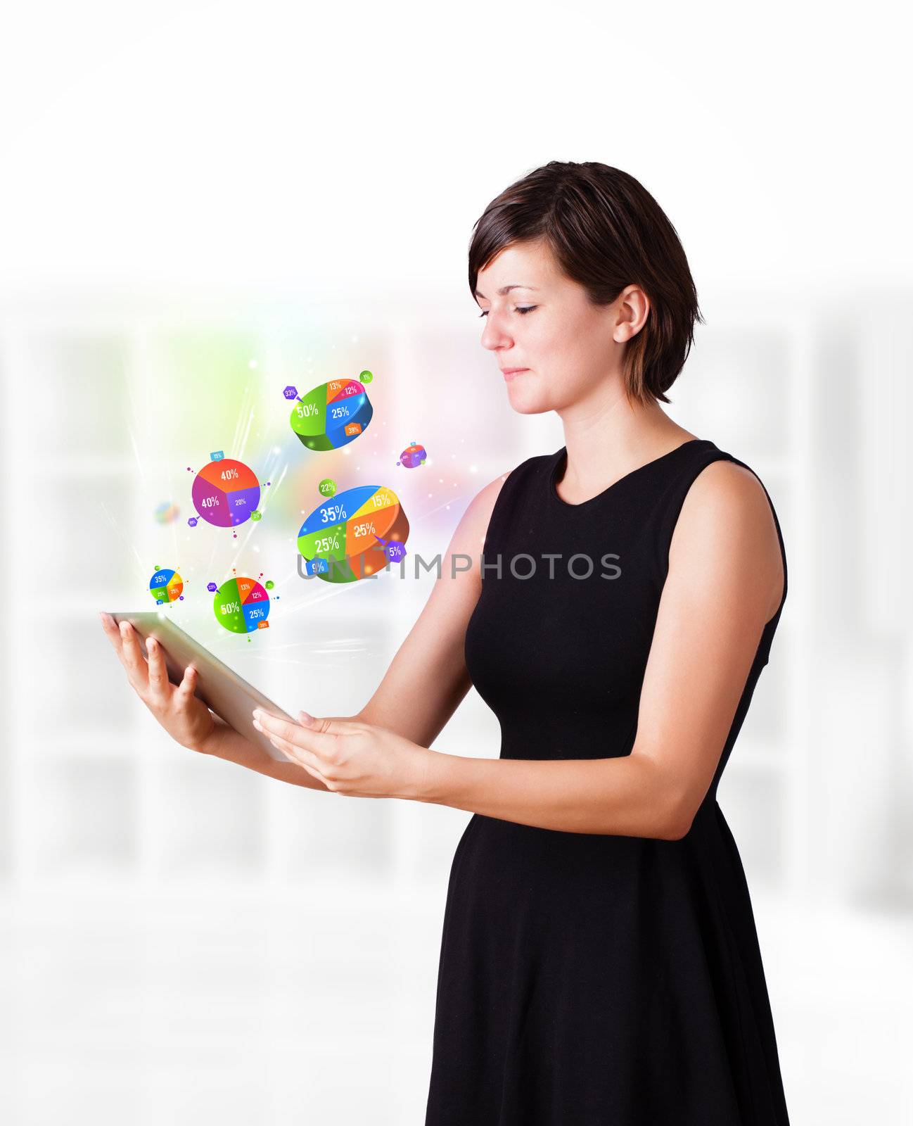 Young business woman looking at modern tablet with colourful pie charts