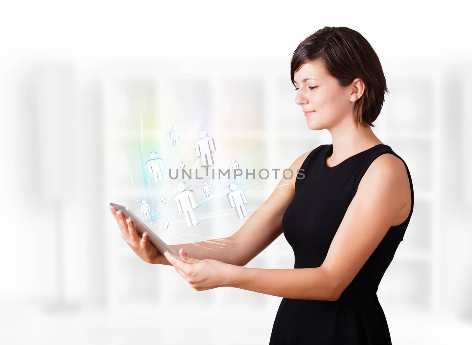 Young woman looking at modern tablet with social icons by ra2studio