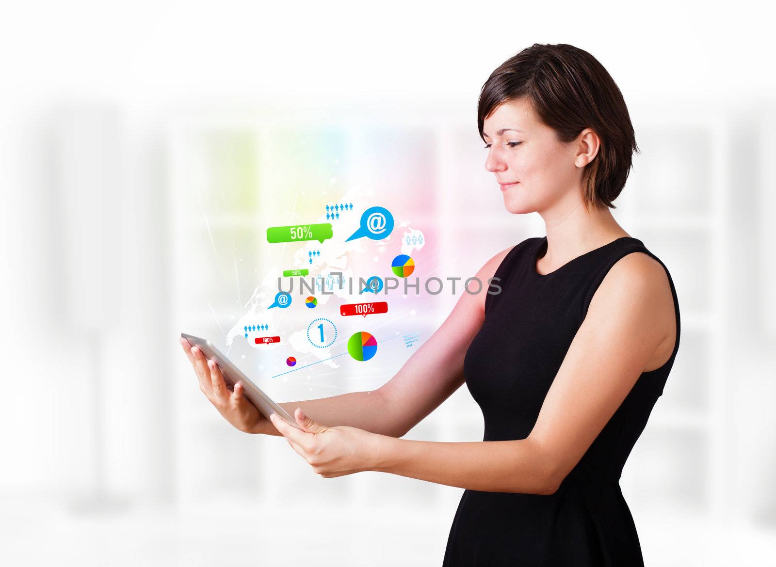 Young business woman looking at modern tablet with colourful technology icons