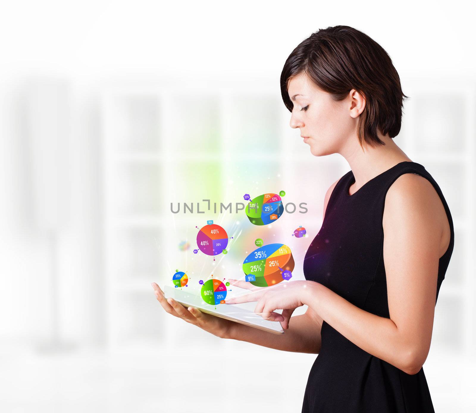 Young business woman looking at modern tablet with colourful pie charts