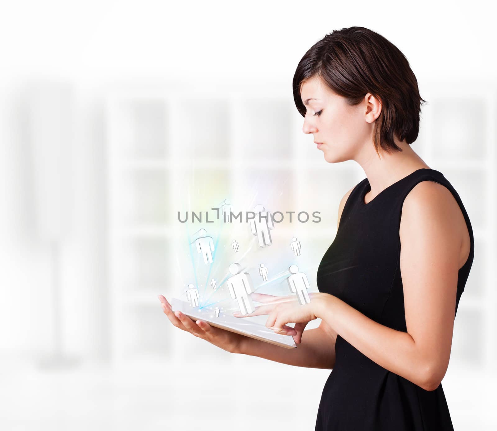 Young woman looking at modern tablet with social icons by ra2studio