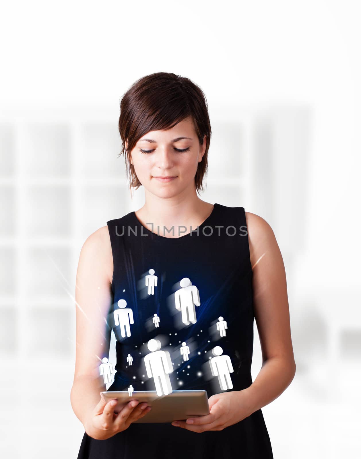 Young woman looking at modern tablet with social icons by ra2studio