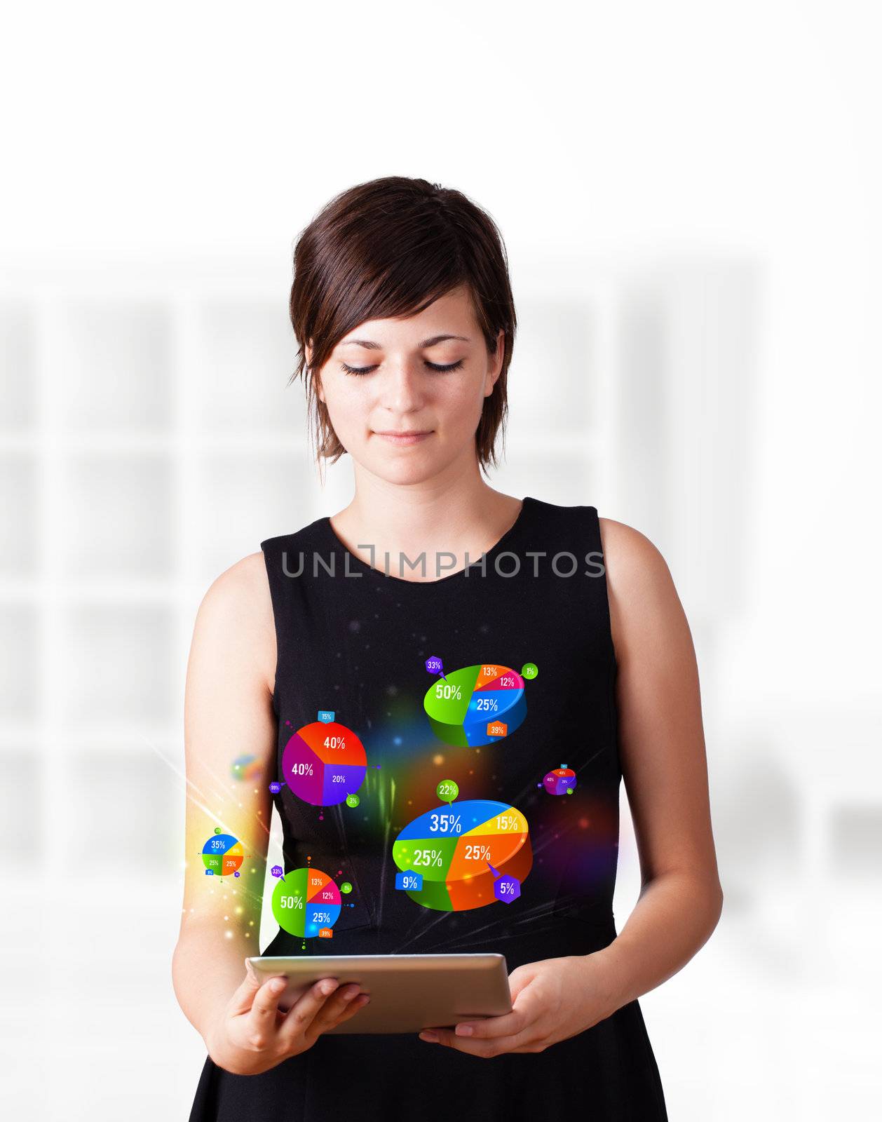 Young business woman looking at modern tablet with colourful pie charts