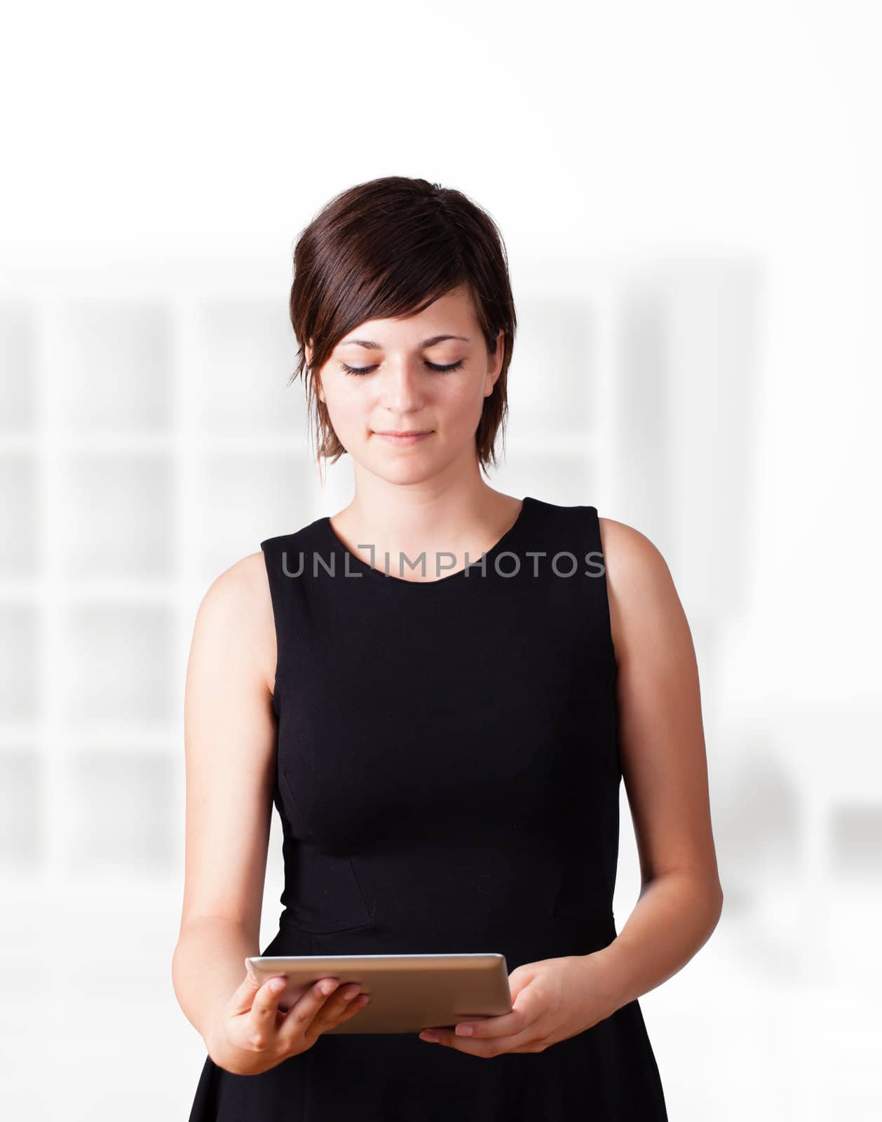 Young business woman looking at modern tablet