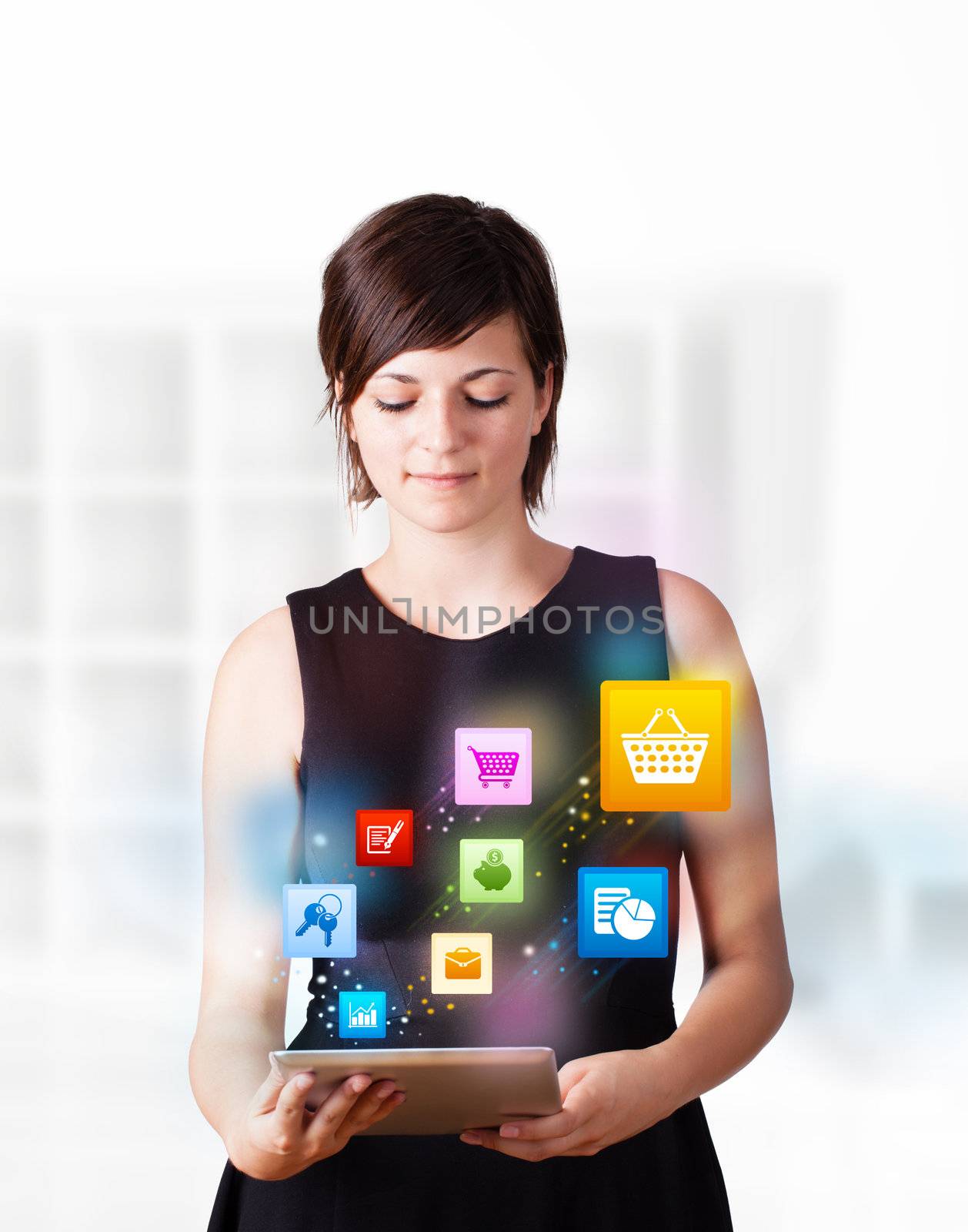 Young woman looking at modern tablet with colourful icons by ra2studio