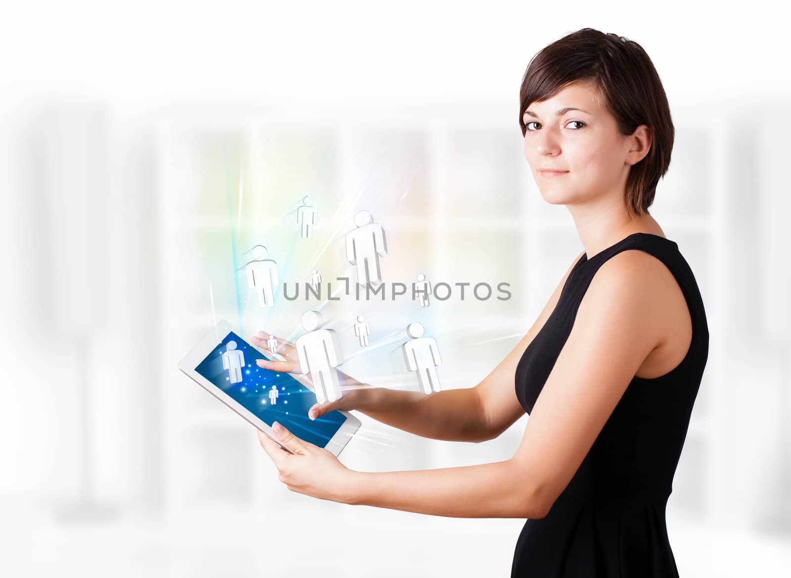 Young business woman looking at modern tablet with social icons