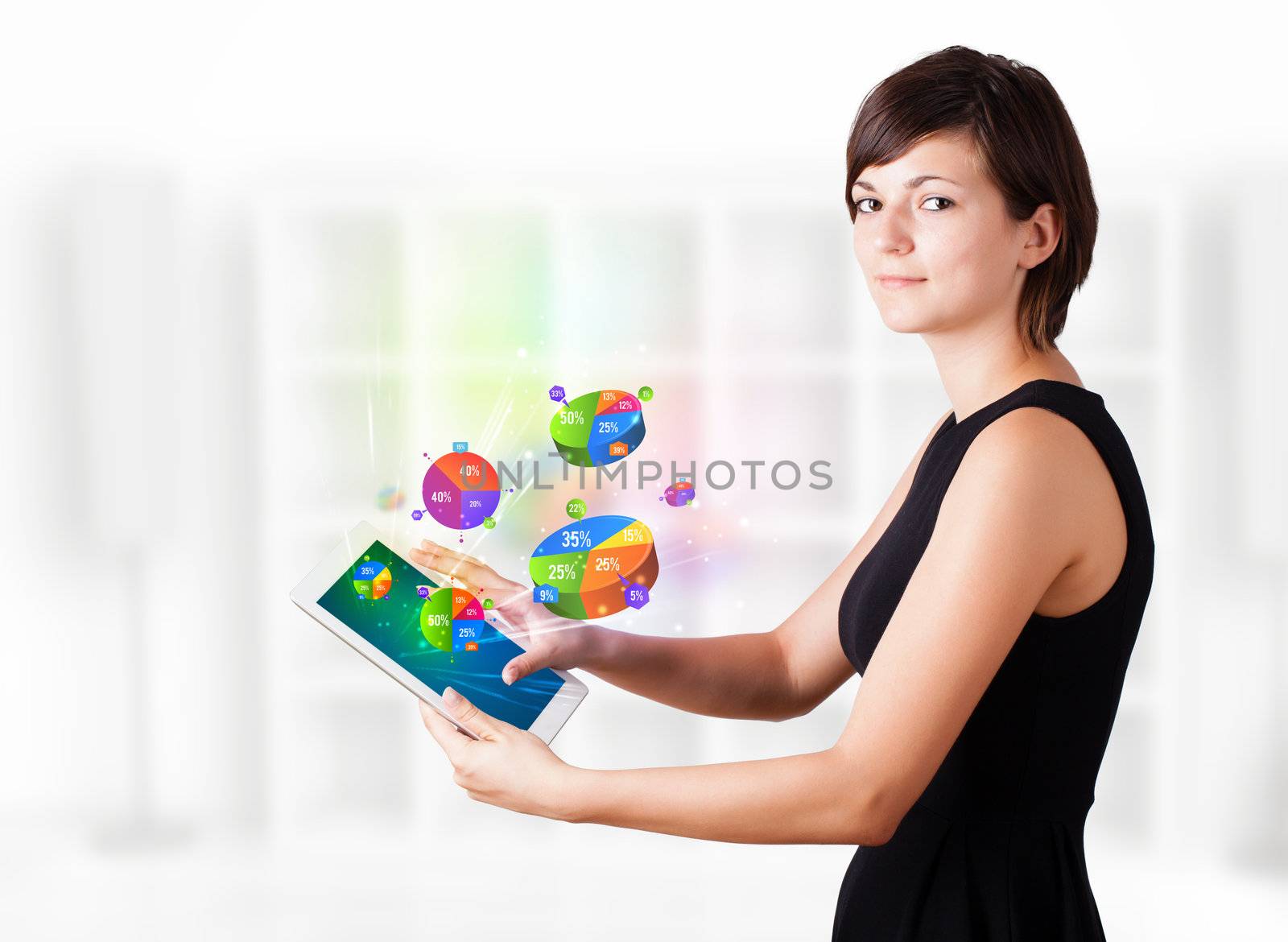 Young woman looking at modern tablet with pie charts by ra2studio