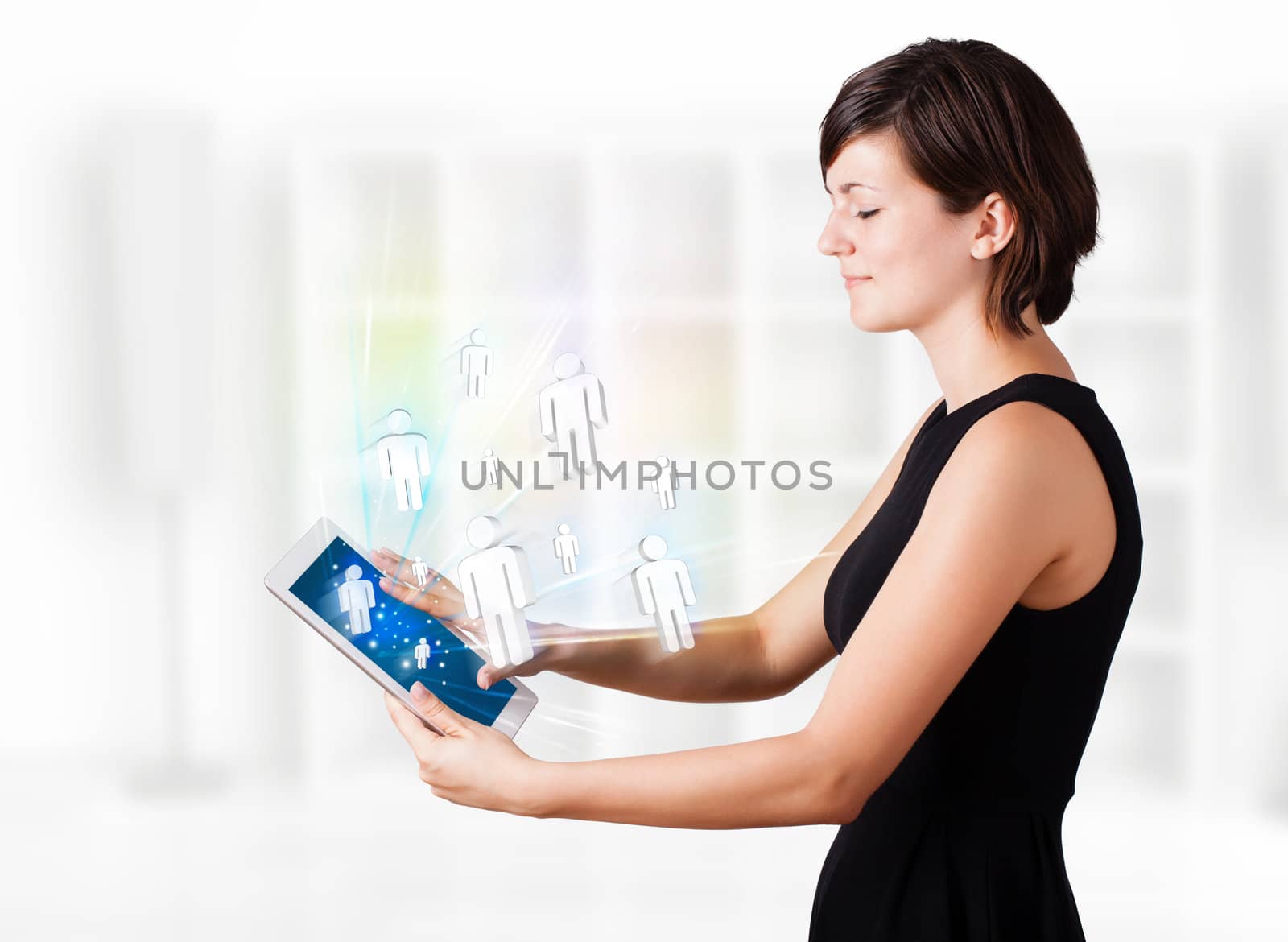 Young woman looking at modern tablet with social icons by ra2studio