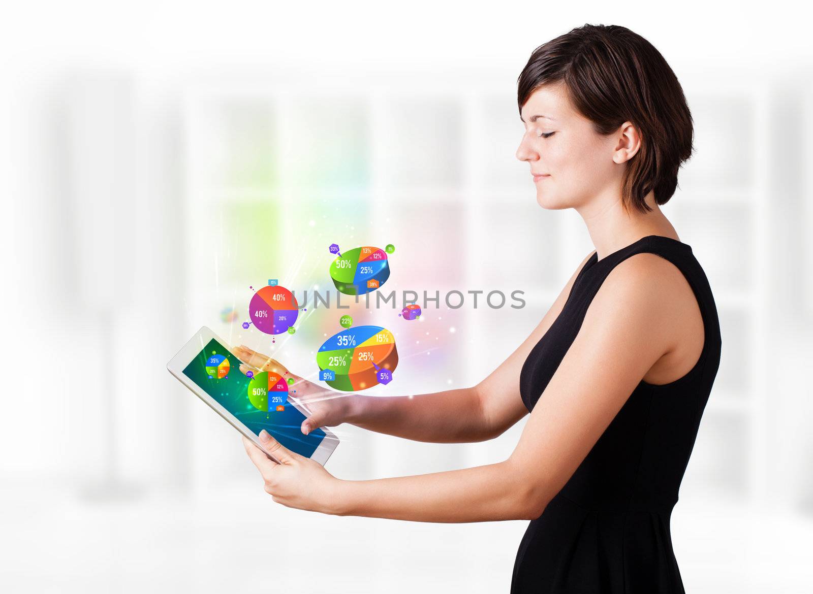 Young woman looking at modern tablet with pie charts by ra2studio