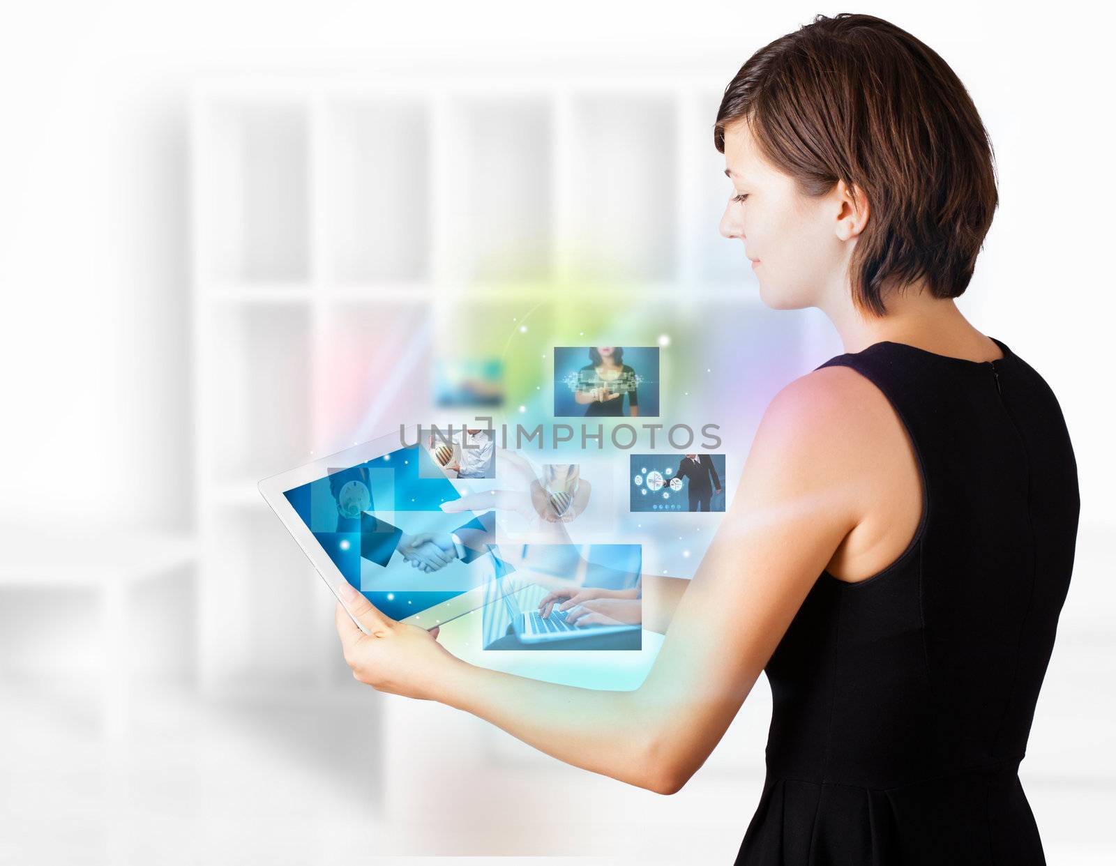 Young business woman browsing pictures on modern tablet