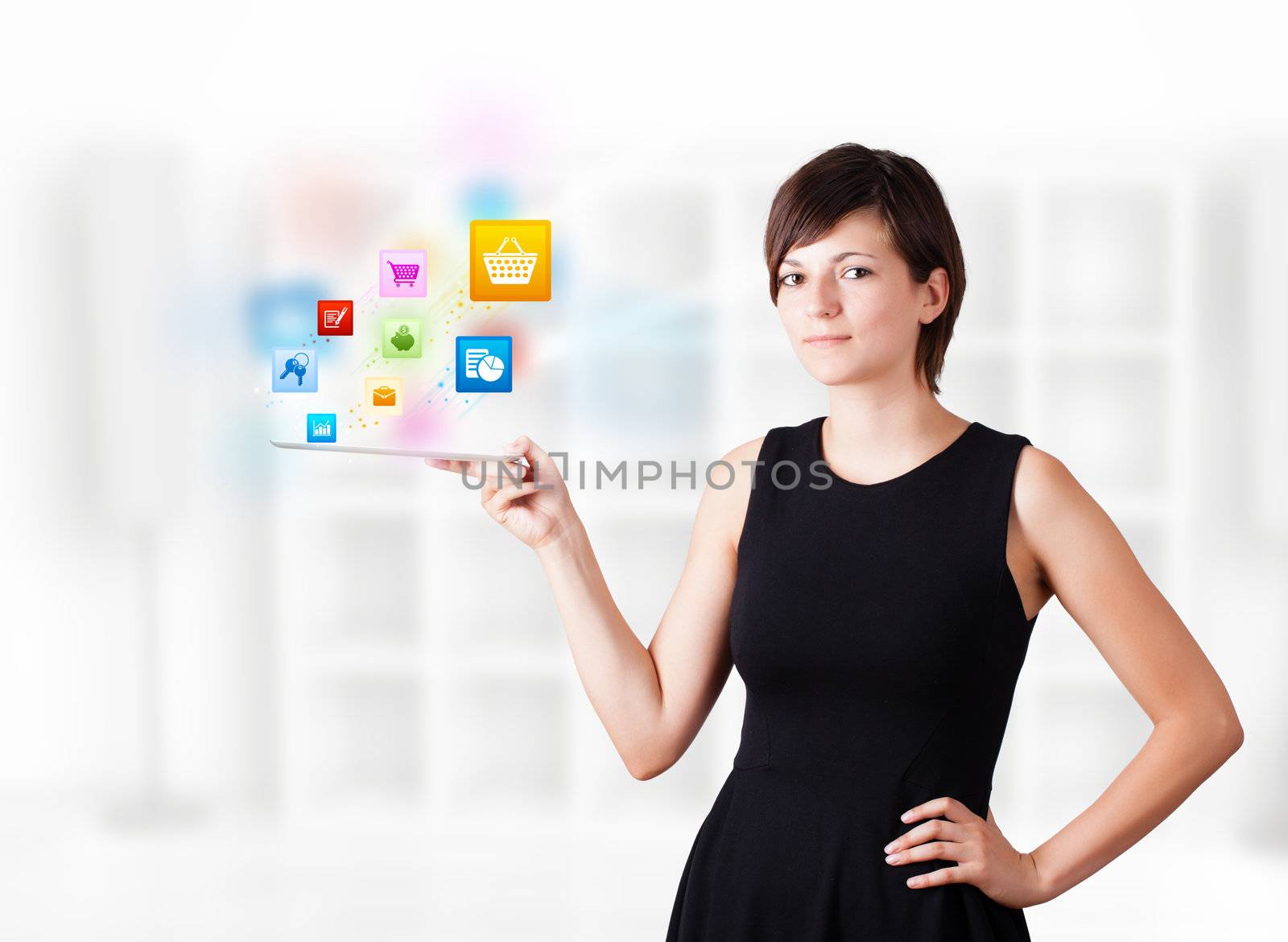 Young woman looking at modern tablet with colourful icons by ra2studio