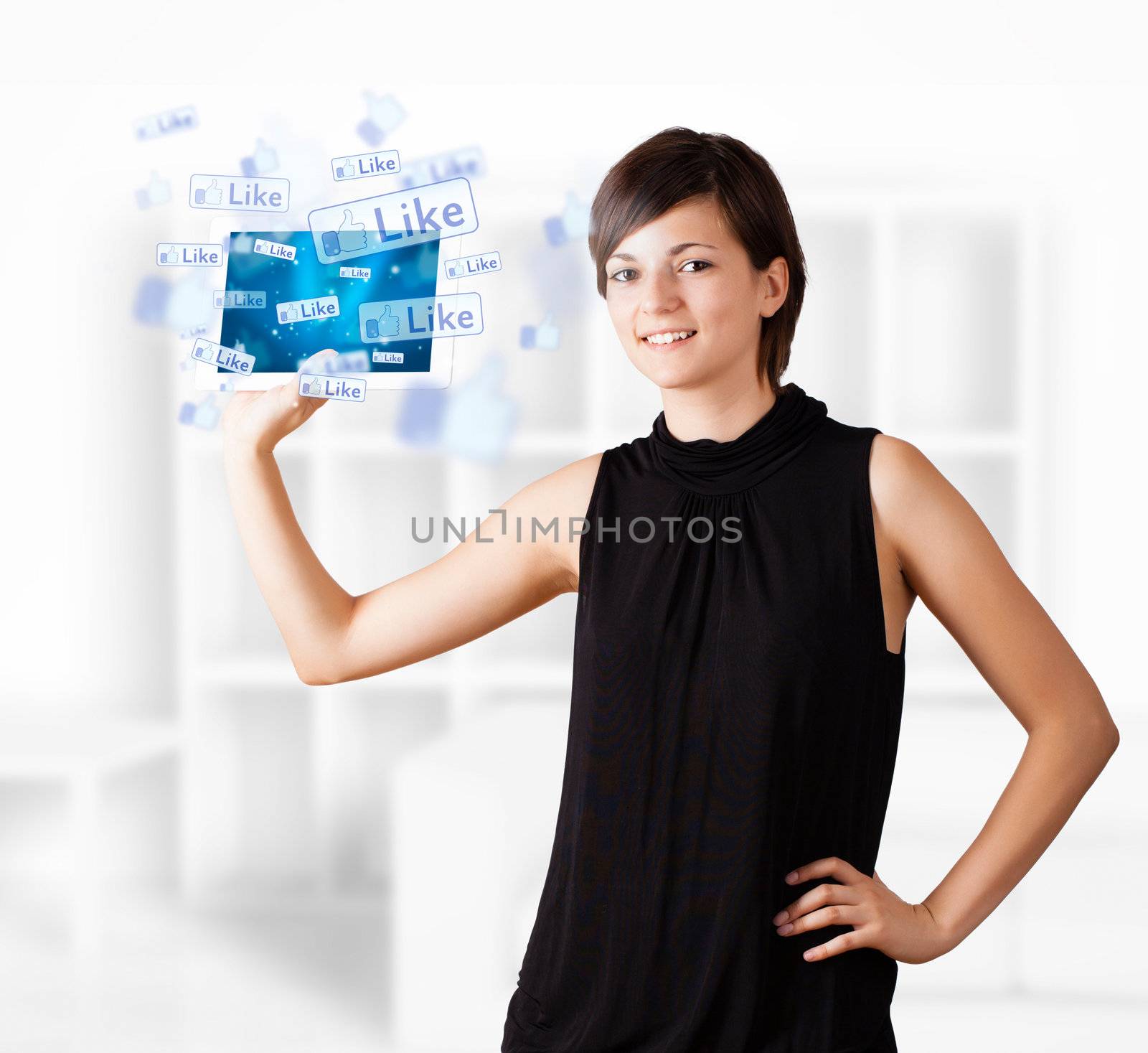Young business woman looking at modern tablet with social icons