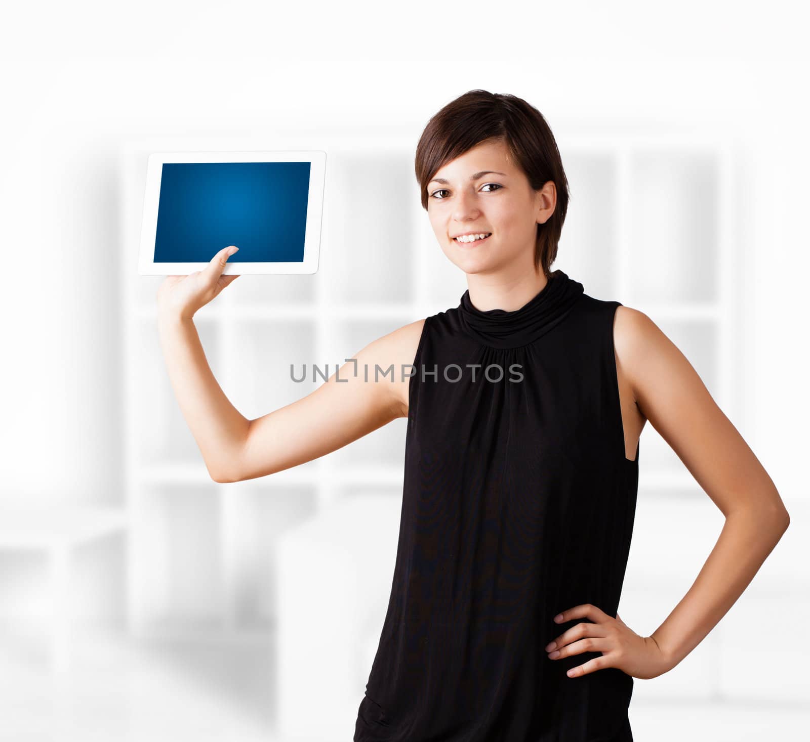 Young business woman looking at modern tablet
