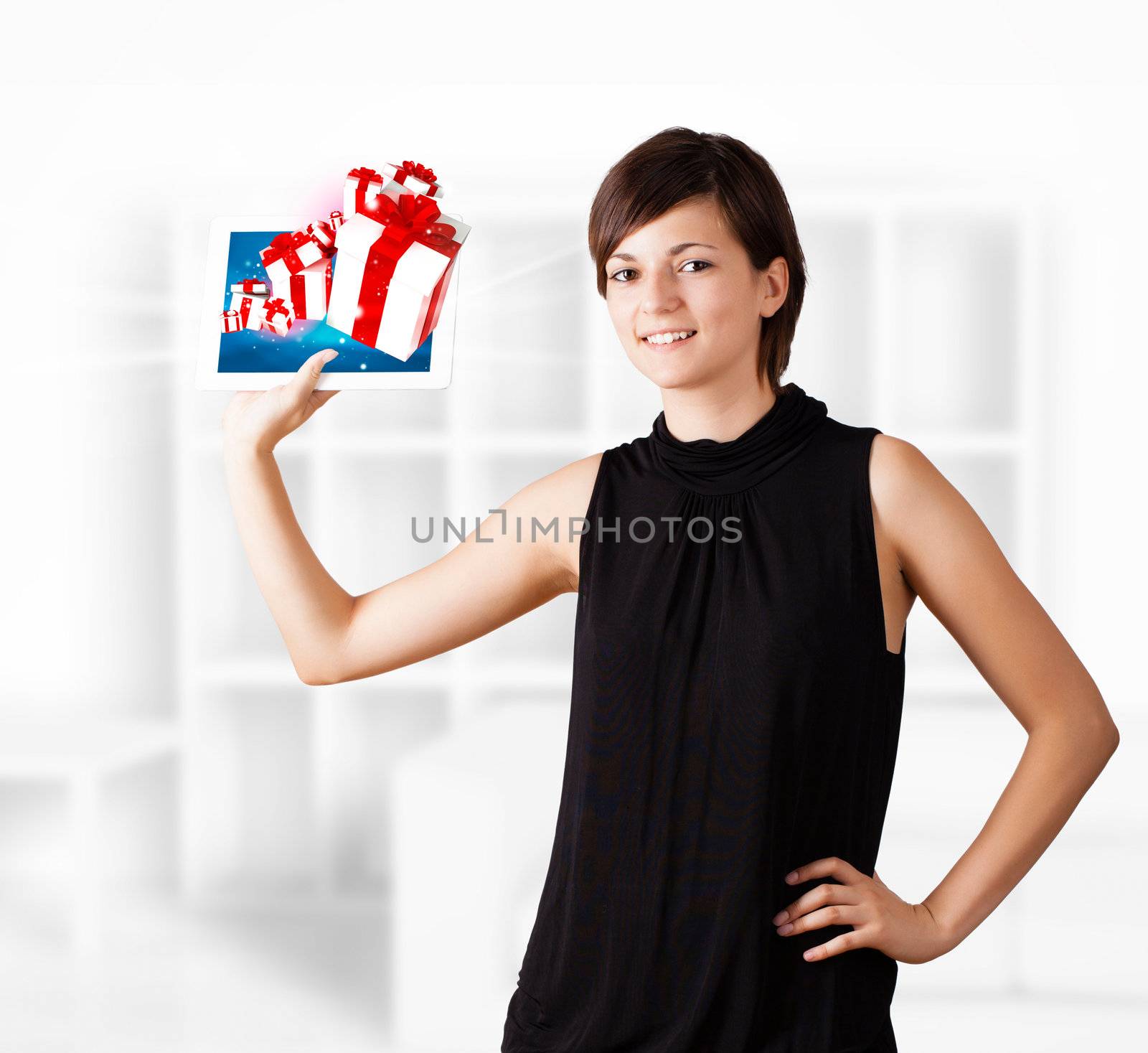 Young business woman looking at modern tablet with present boxes