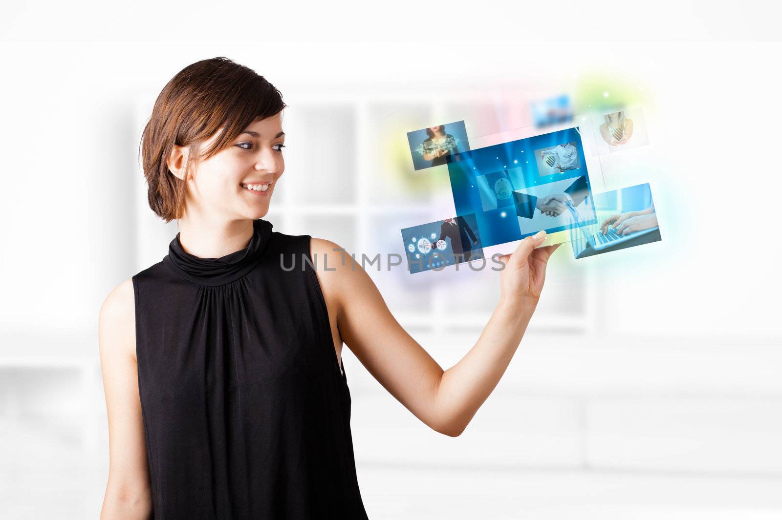 Young woman browsing pictures on modern tablet by ra2studio