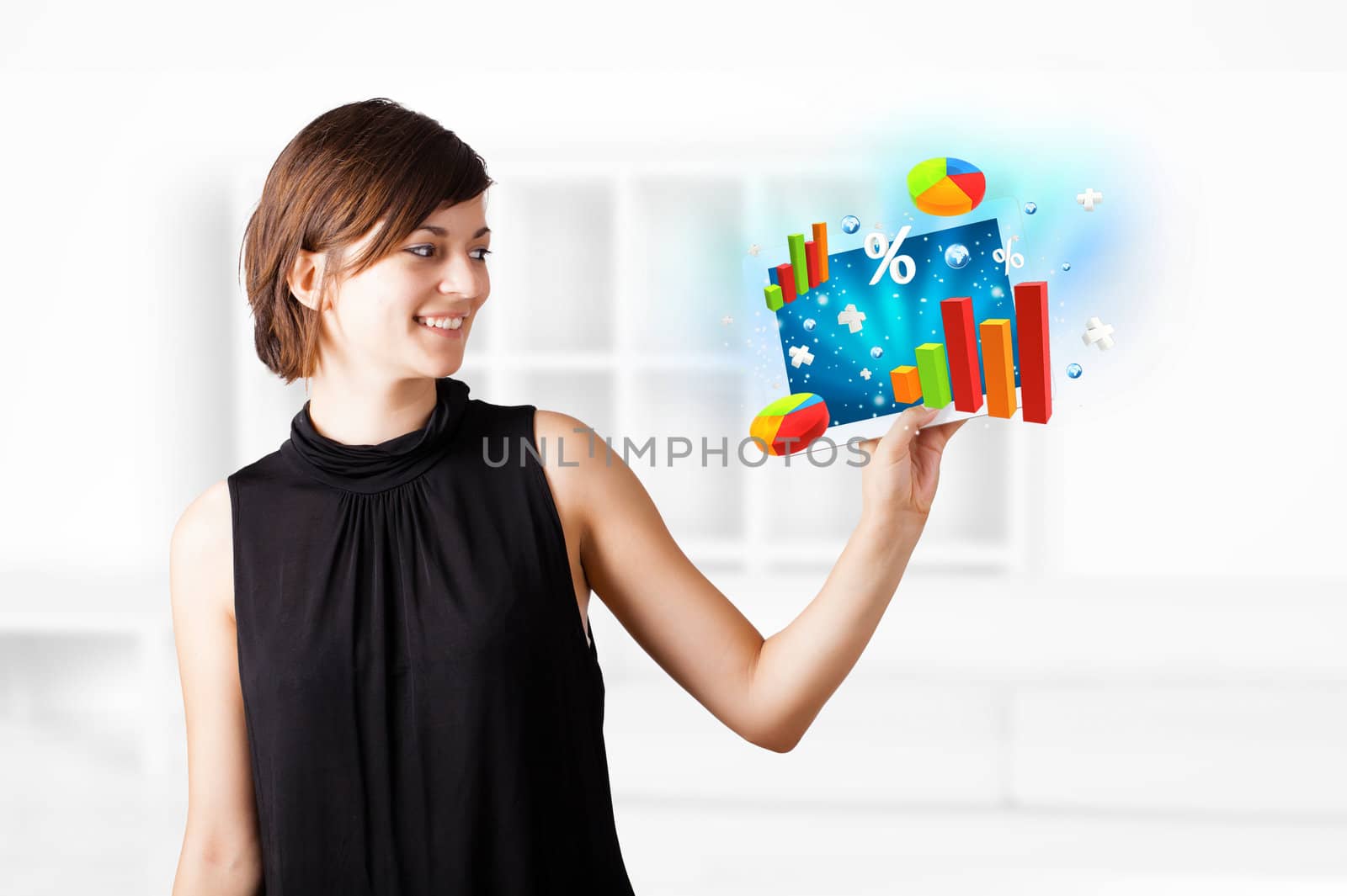 Young business woman looking at modern tablet with colourful diagrams