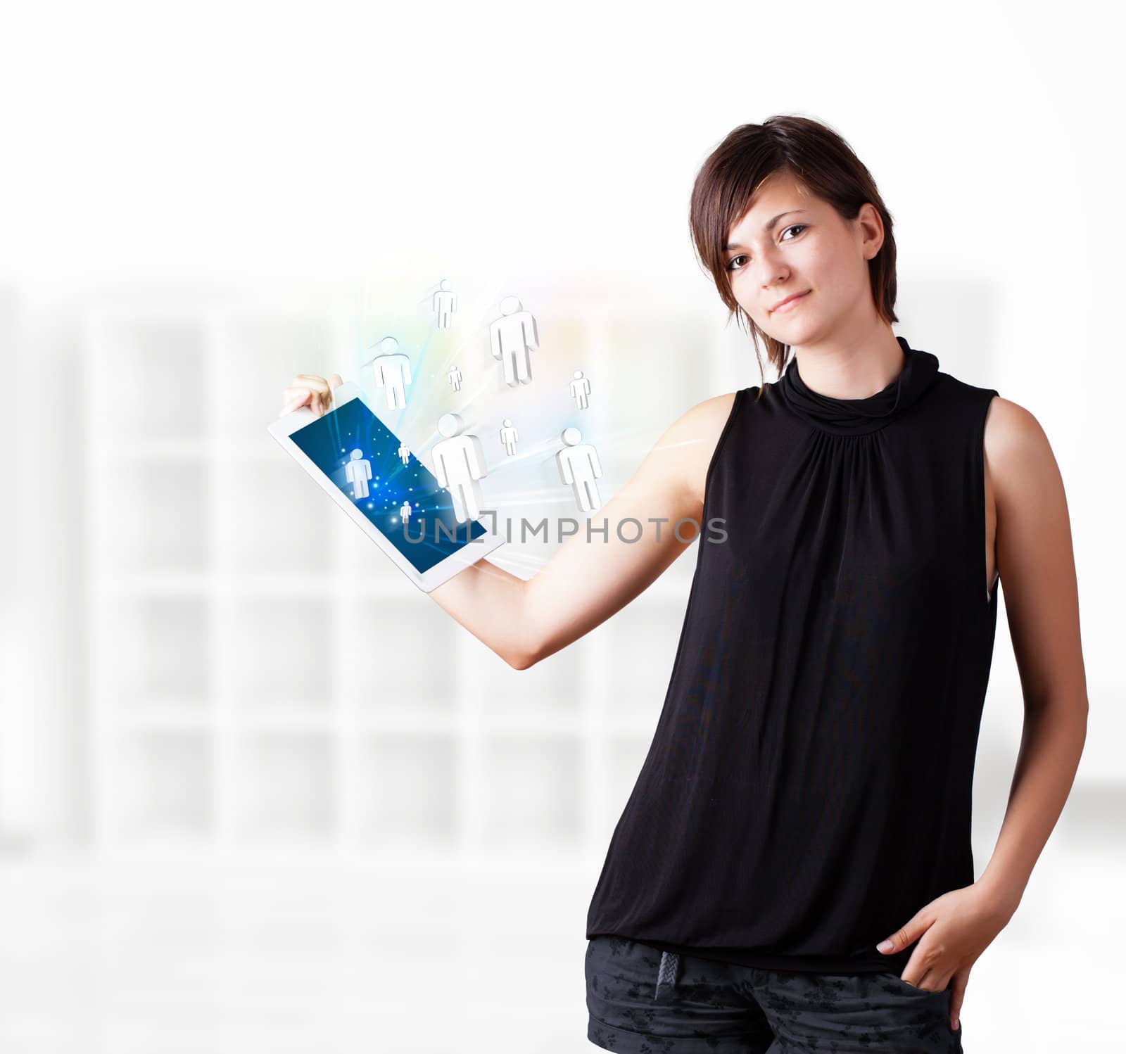 Young woman looking at modern tablet with social icons by ra2studio